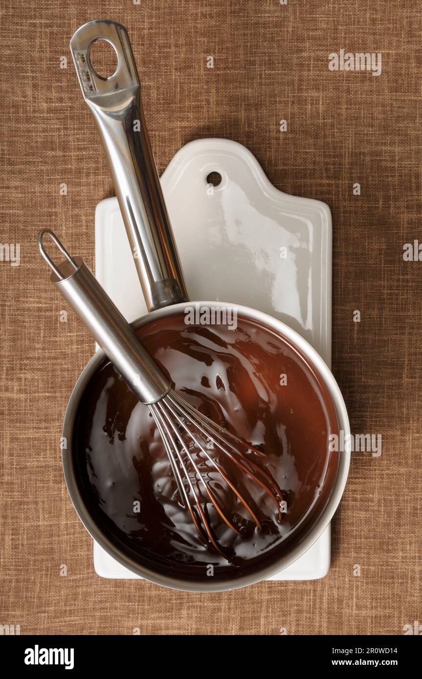 Saucepan of melted chocolate Stock Photo