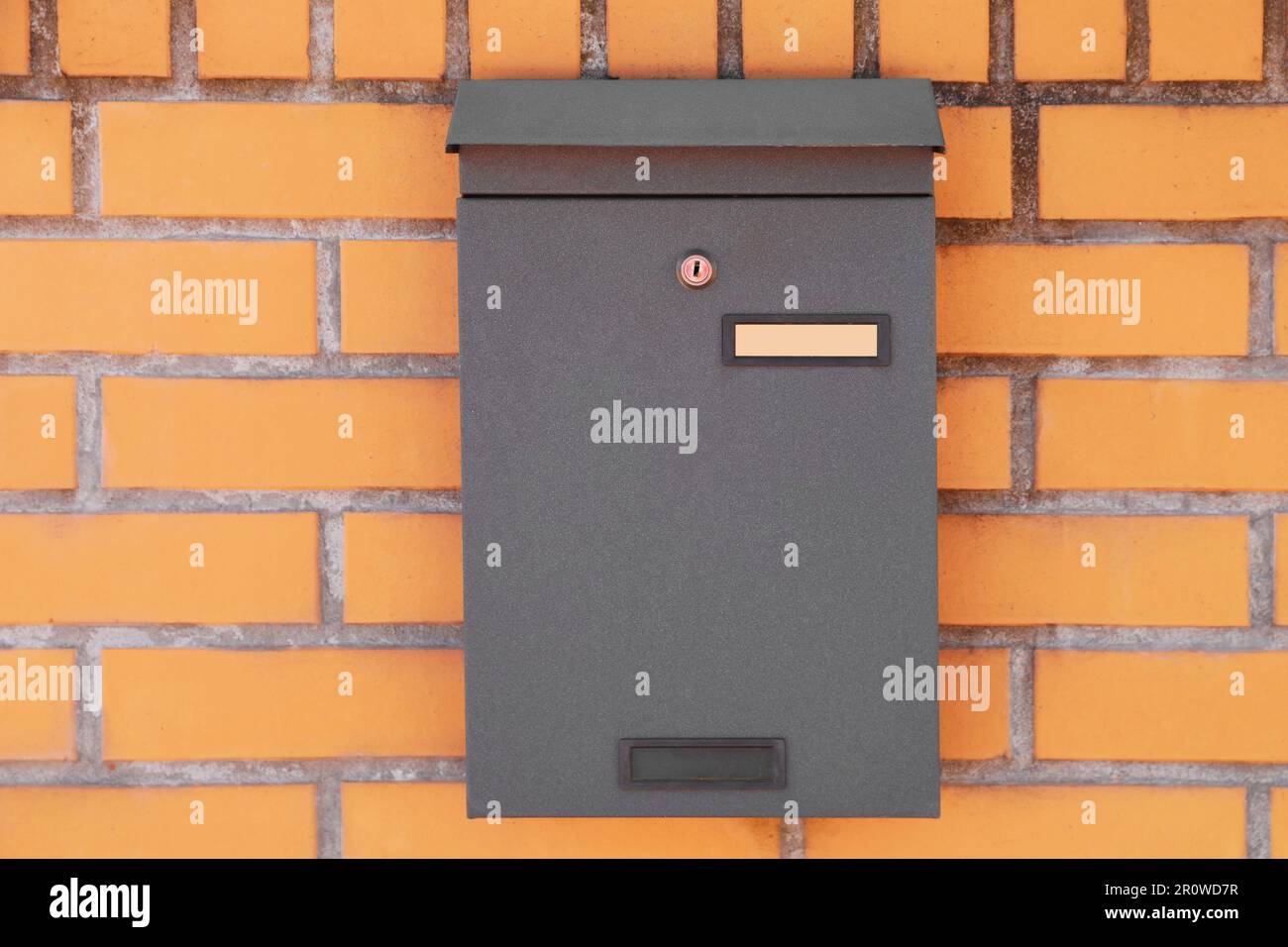 Black metal letter box on red brick wall Stock Photo Alamy