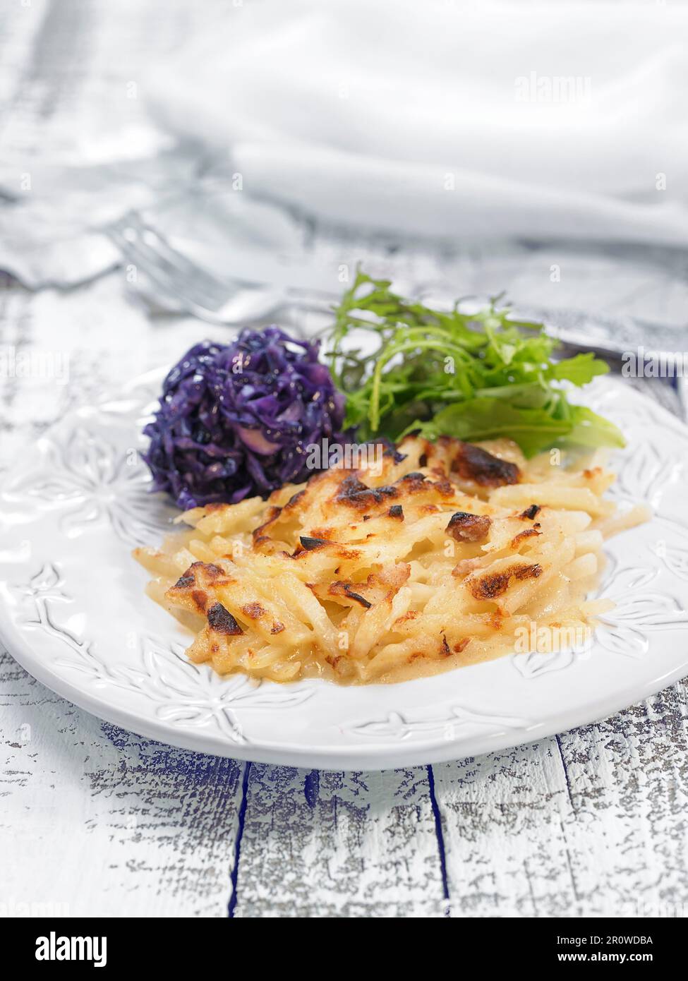 Potato gratin with red cabbage and rocket lettuce Stock Photo Alamy