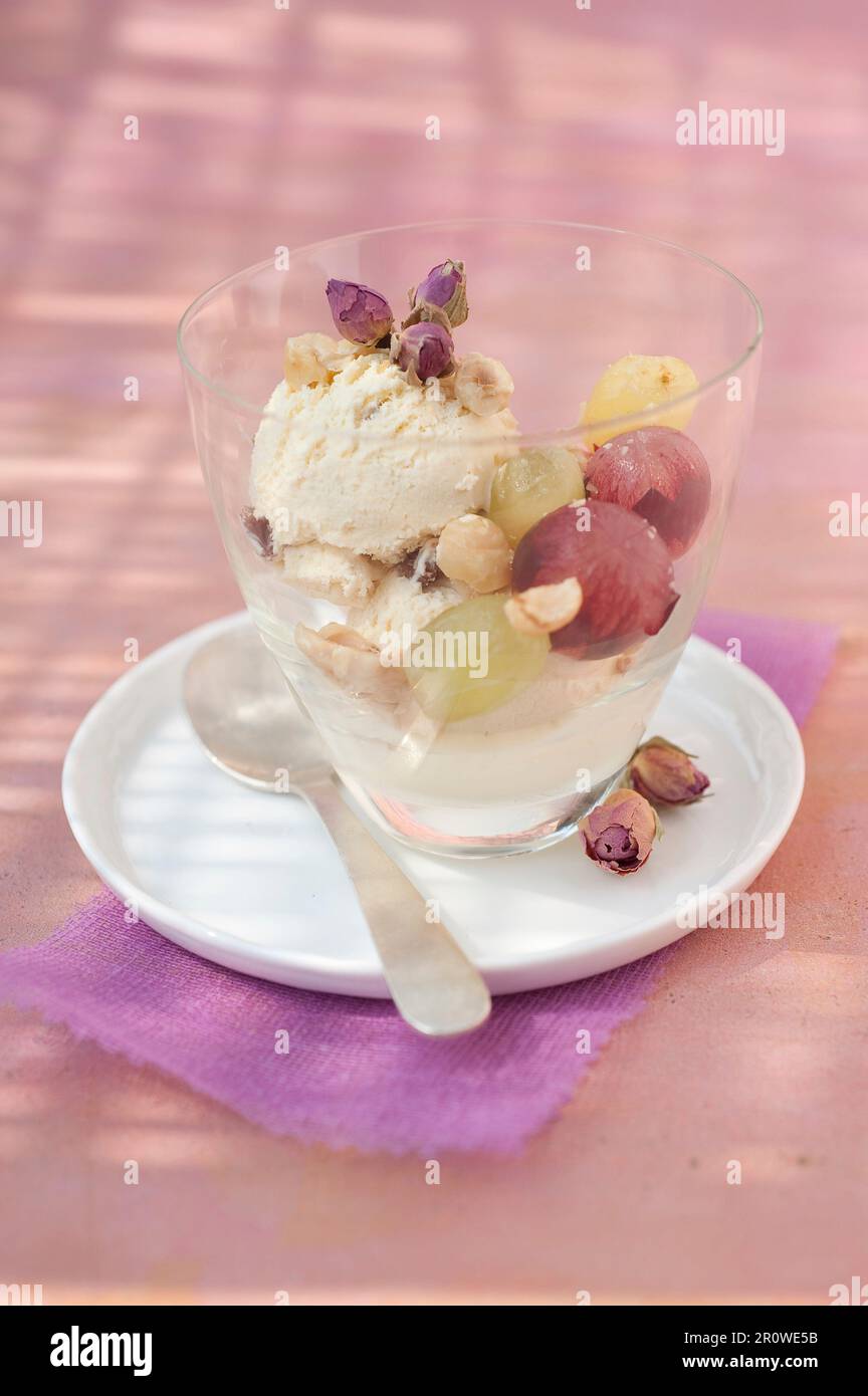 Rumraisin ice cream,crushed hazelnuts and fresh grapes Stock Photo Alamy