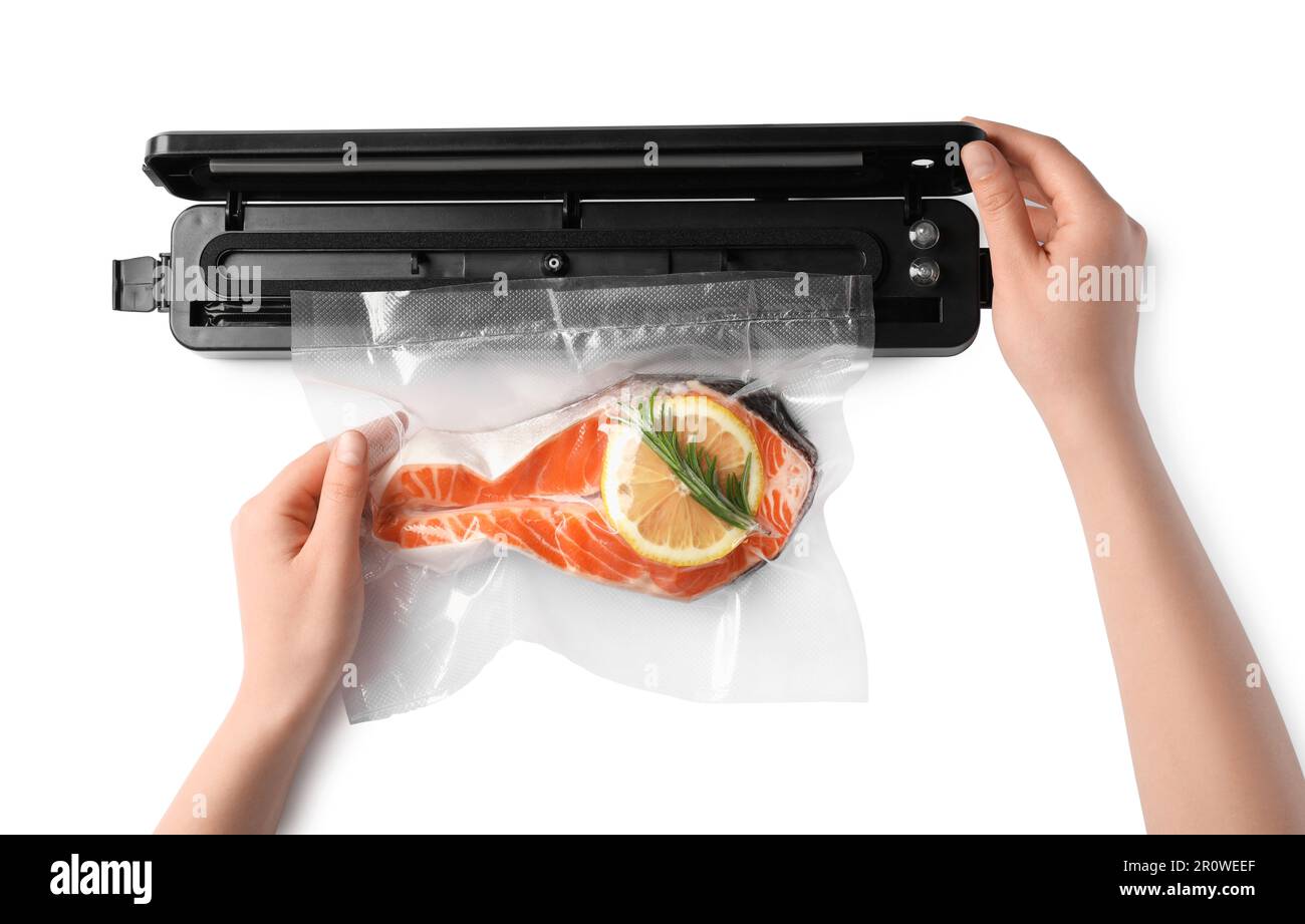 Woman using vacuum sealer on white background, top view. Salmon with