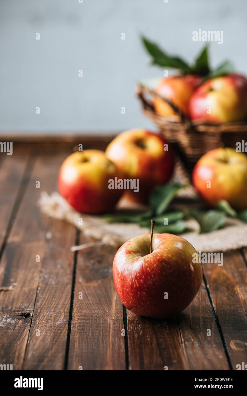 selective focus of fresh apples on dark wooden surface Stock Photo