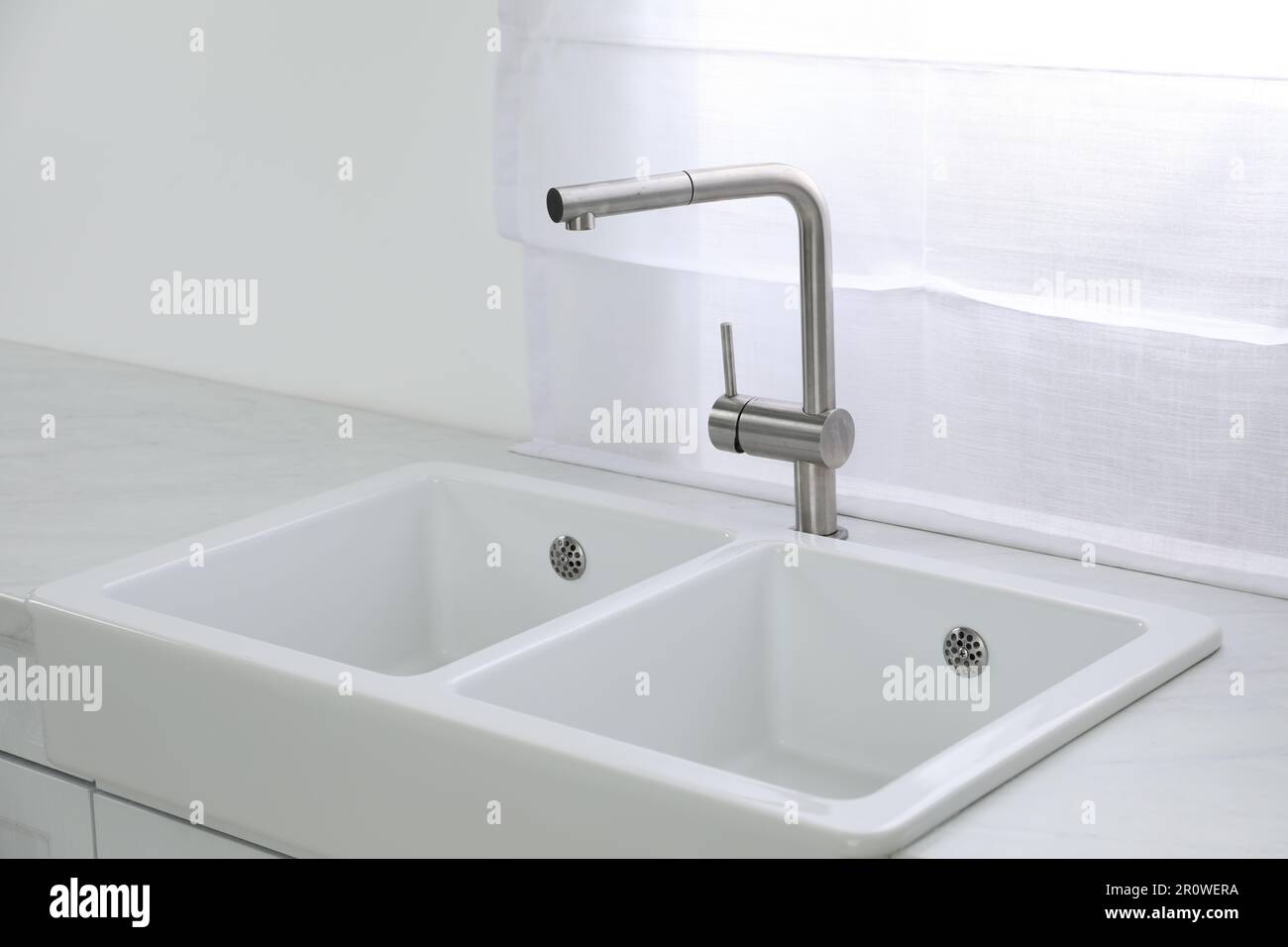 Modern sink and water tap near window in kitchen. Interior design Stock ...