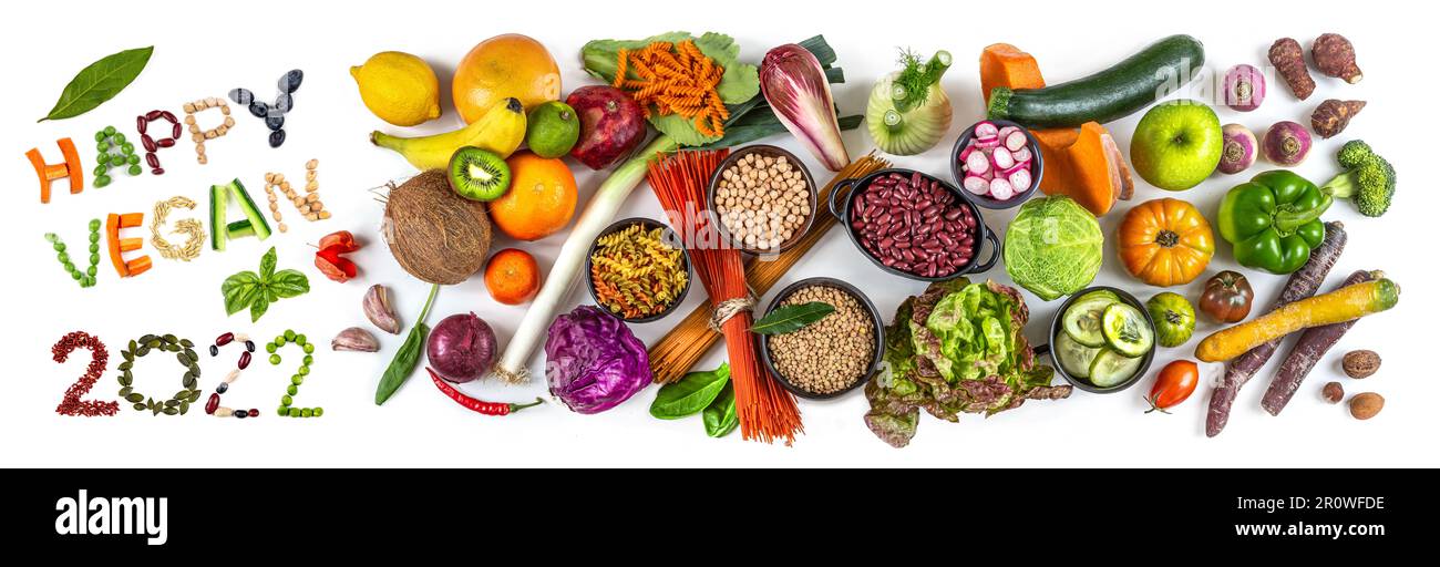 Happy vegan 2022' next to fruit, vegetables and cereals Stock Photo