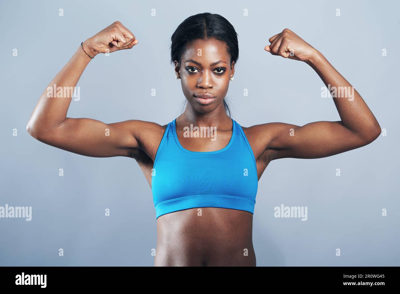 Power, fitness and portrait of black woman flexing arm muscles for