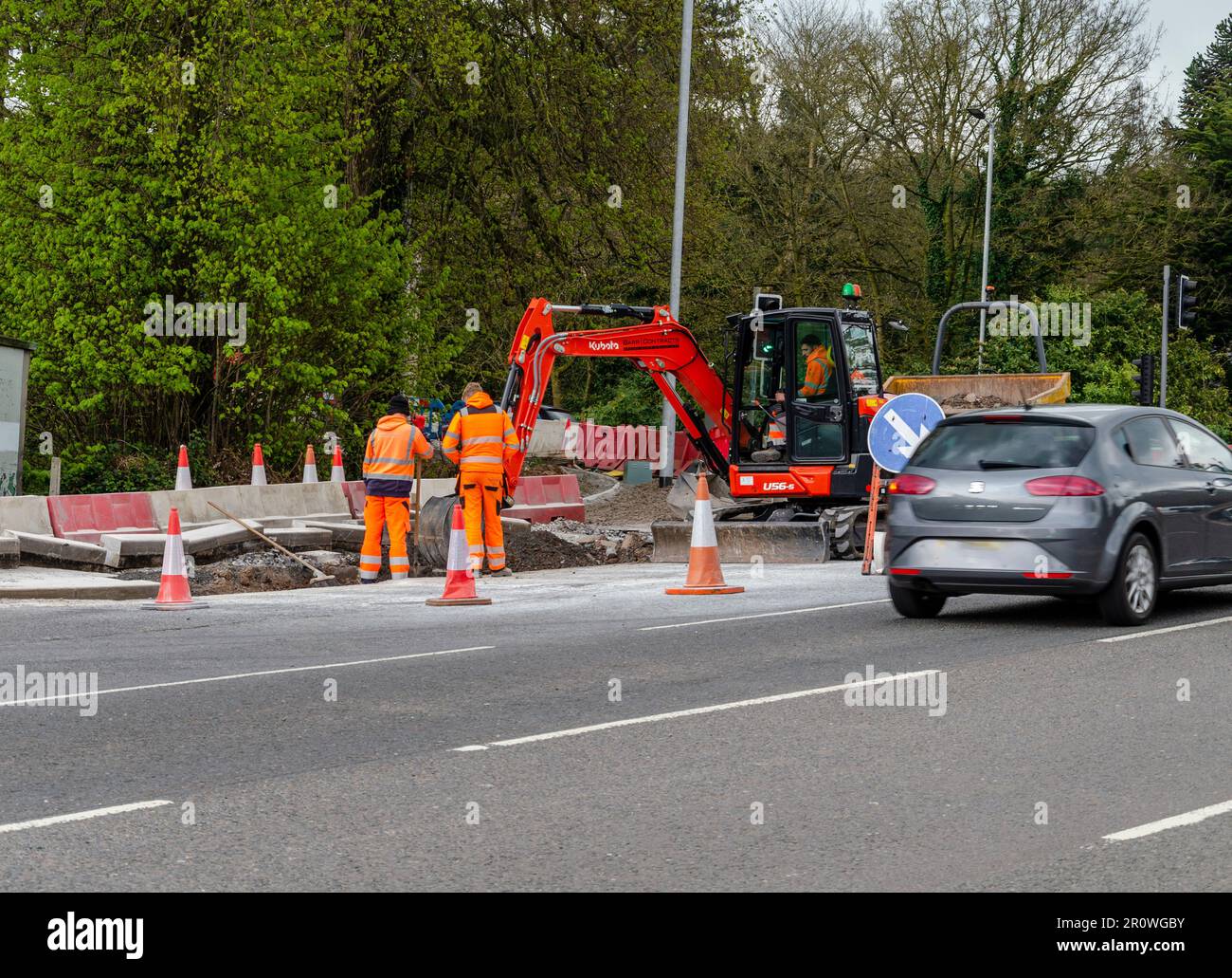 Castlereagh, Belfast County Down, Northern Ireland, April 26 2023 - Two workmen watching another man operating a mechanical digger Stock Photo