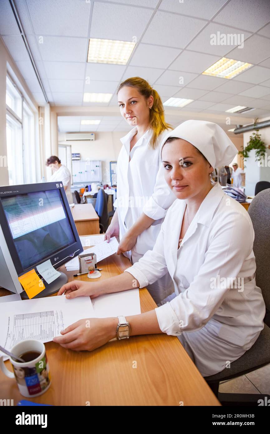 Kostanay, Kazakhstan - May 14, 2012: Bayan-Sulu modern confectionery factory. Young women workers in laboratory Stock Photo