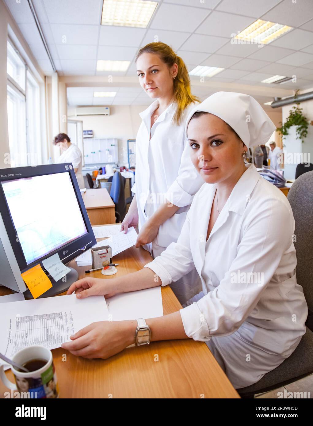 Kostanay, Kazakhstan - May 14, 2012: Bayan-Sulu modern confectionery factory. Young women workers in laboratory Stock Photo