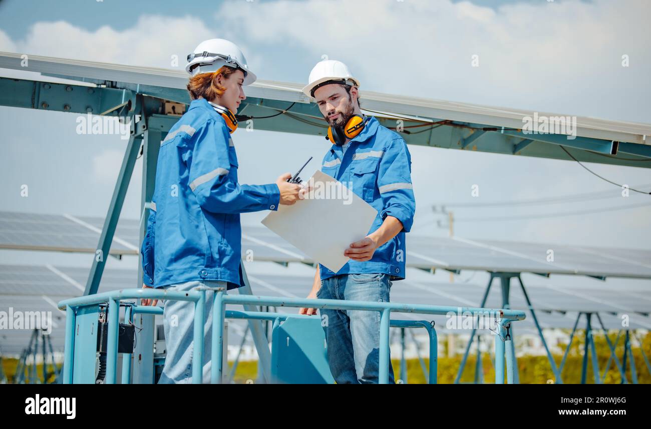 Solar engineers visually examine panel arrays on farm sites using ...