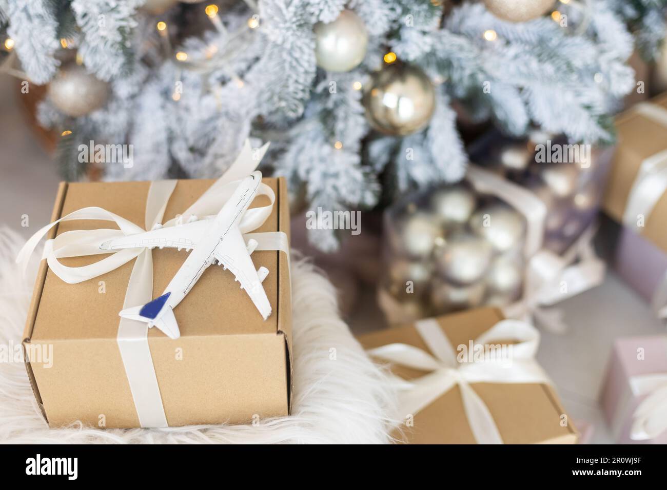 Beautiful Christmas gift boxes on floor near fir tree in room Stock ...