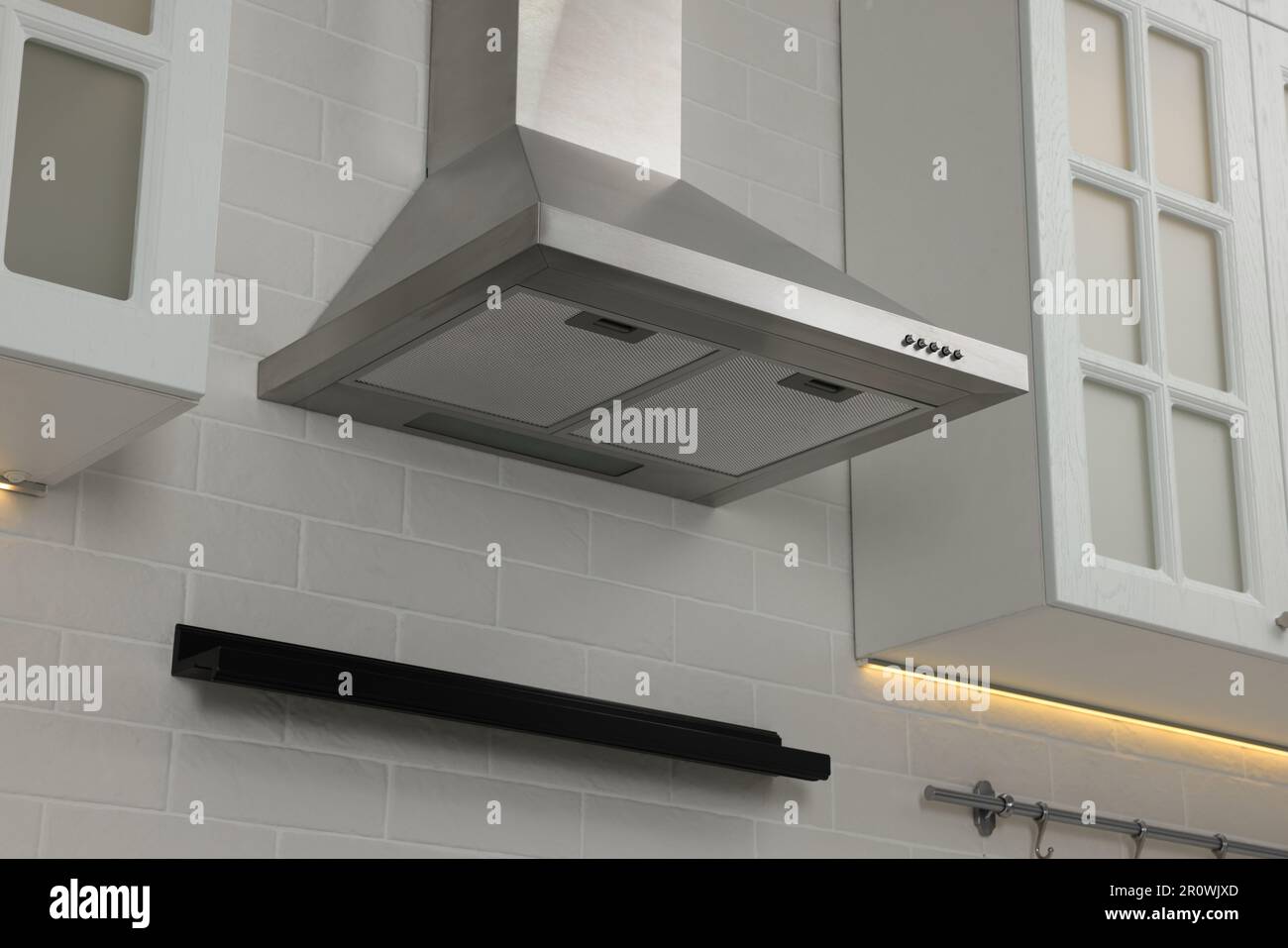 Modern range hood and furniture in kitchen Stock Photo
