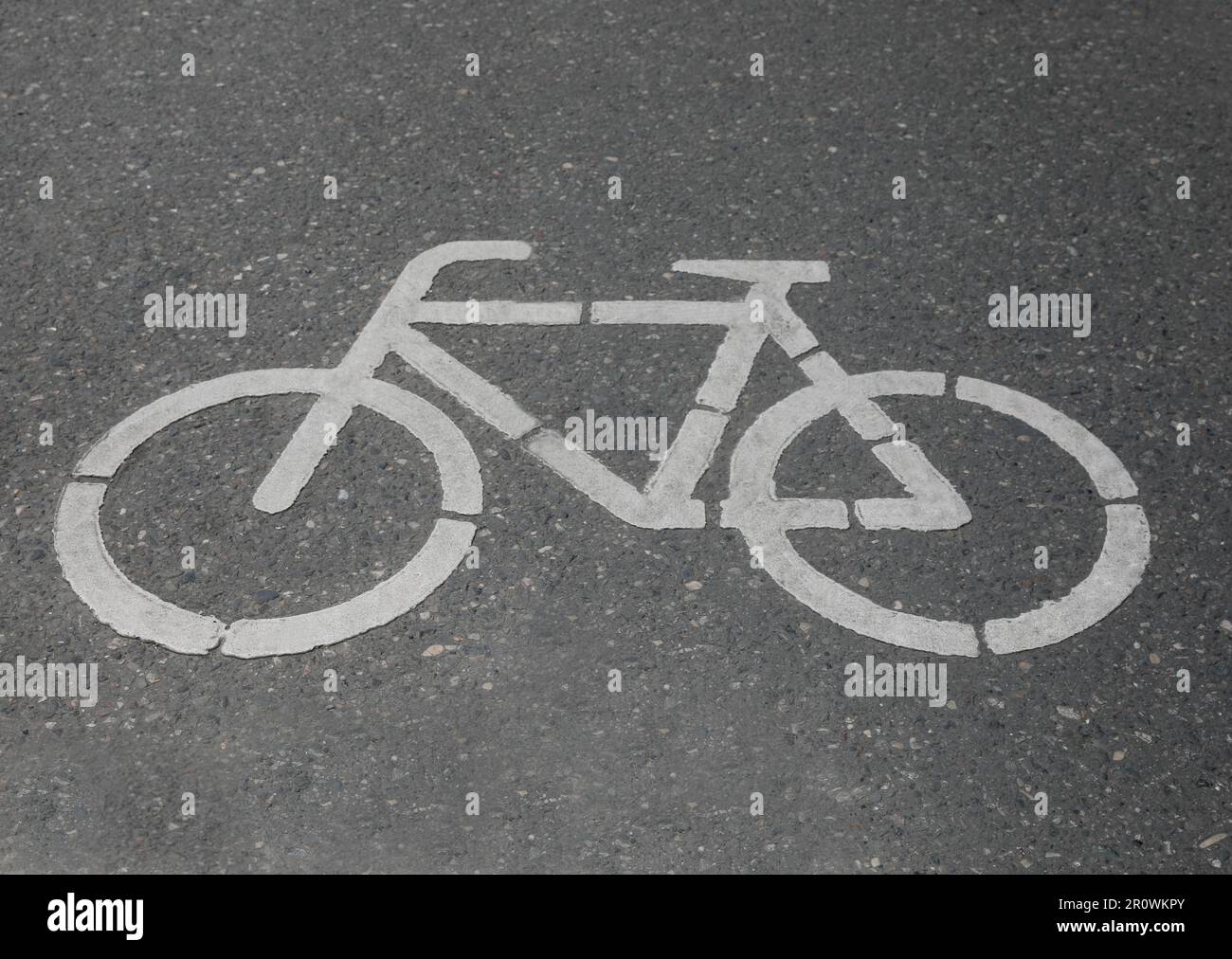 Bicycle lane with white sign painted on asphalt Stock Photo - Alamy