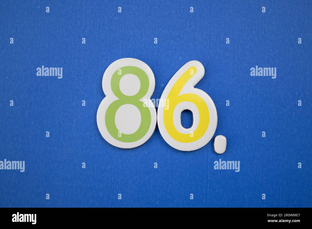 The number 86, placed on a blue background, photographed from above