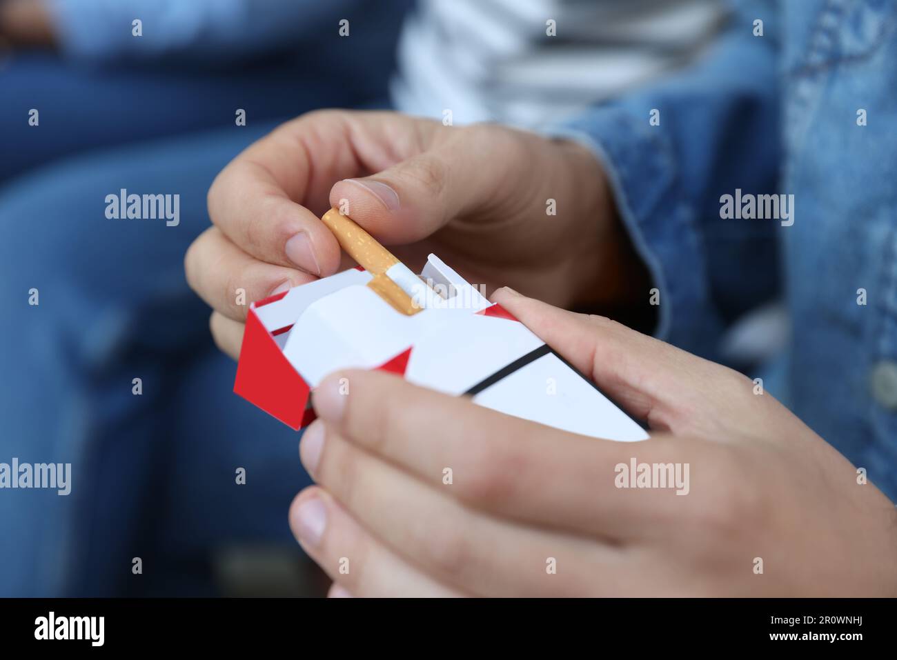 how to tap a cigarette out of the pack Man taking cigarette out of pack outdoors, closeup Stock Photo