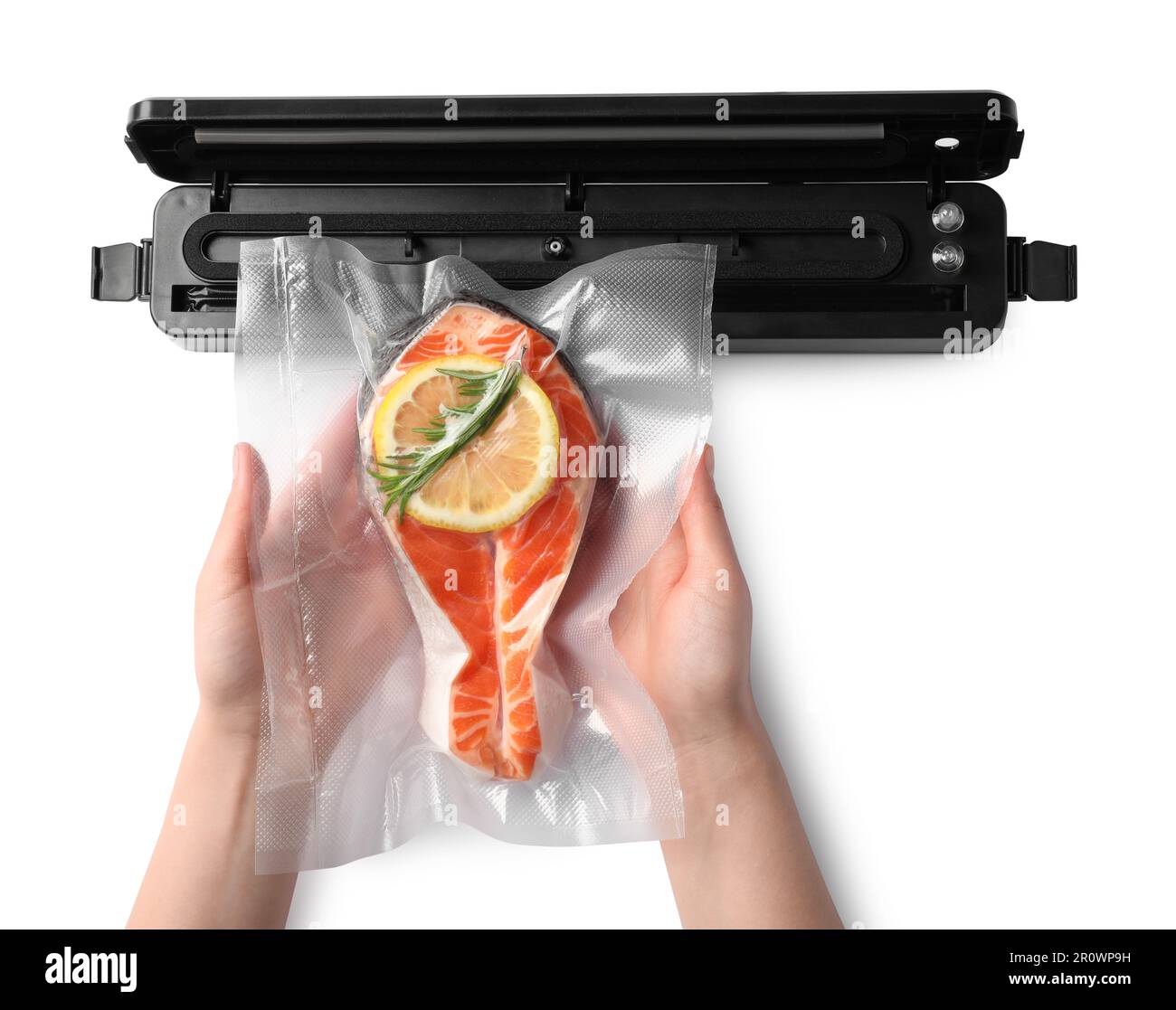 Woman using vacuum sealer on white background, top view. Salmon with