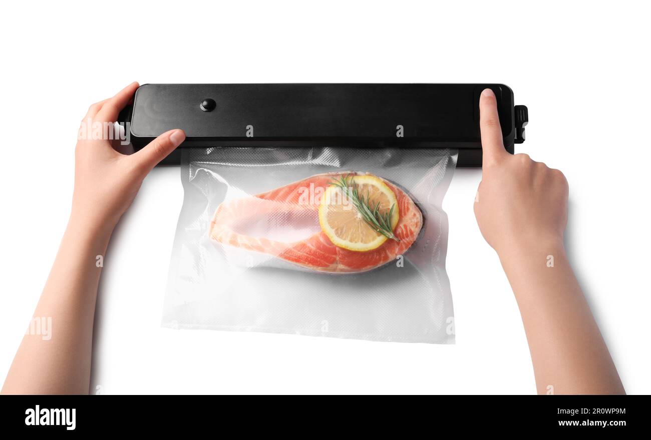 Woman using vacuum sealer on white background, top view. Salmon with