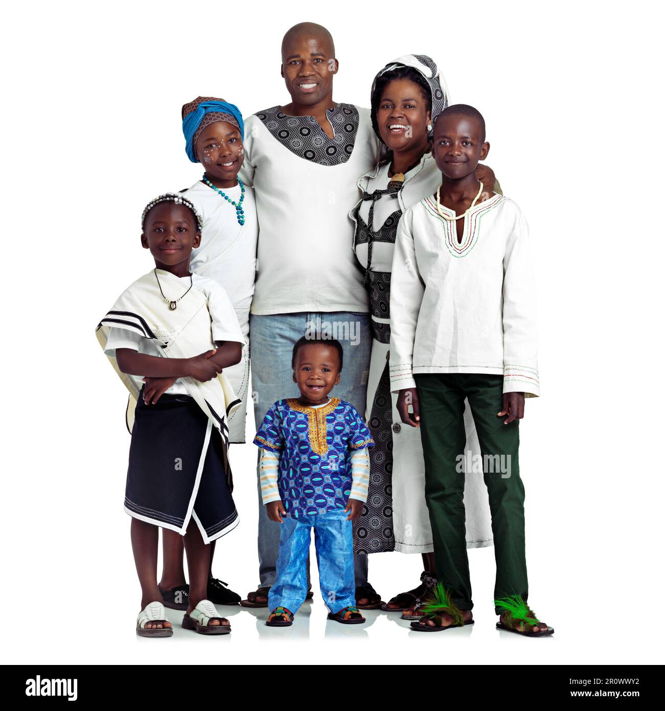 Passing down their culture. Studio shot of a traditional african family isolated on white. Stock Photo