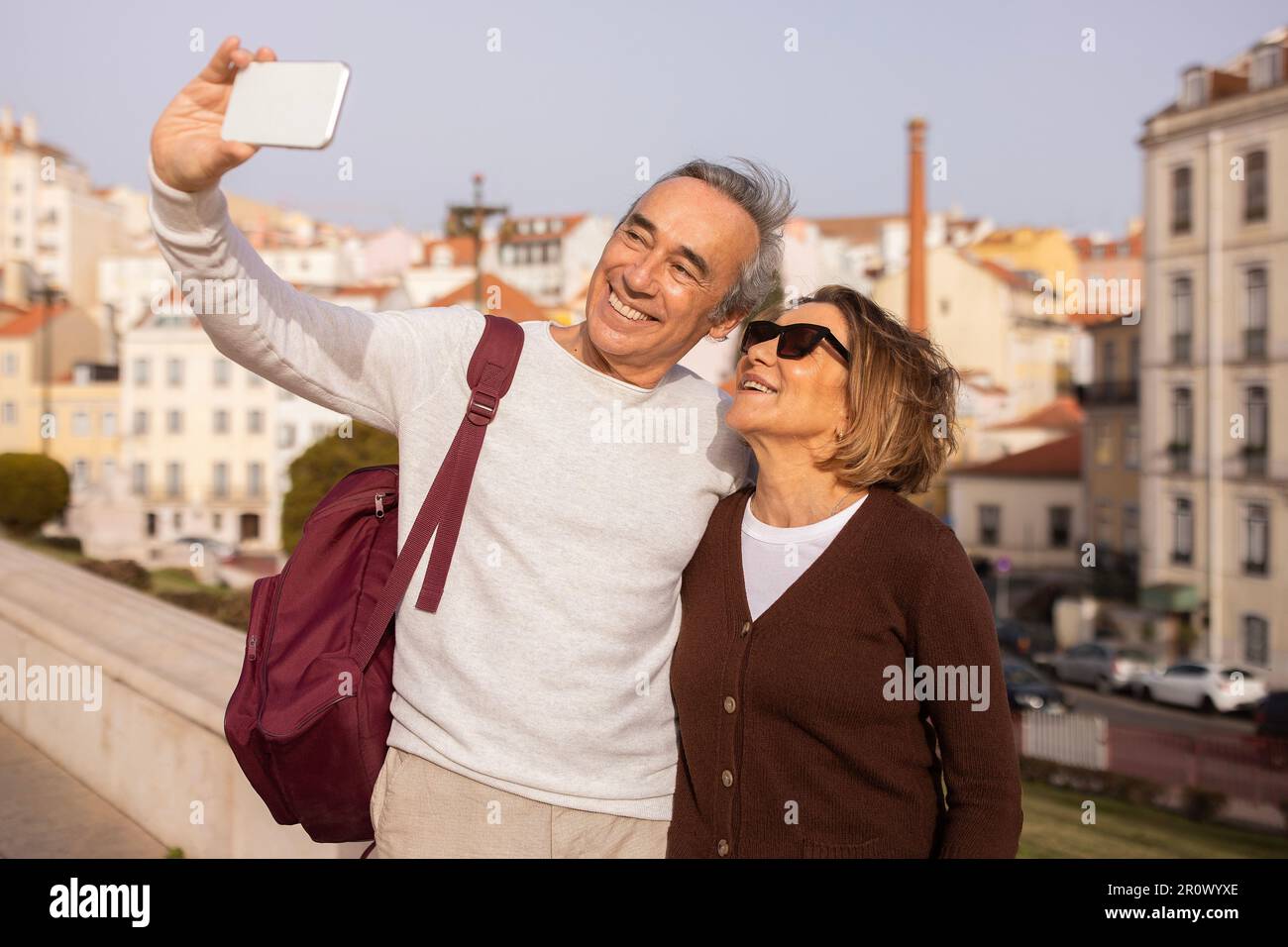 Joyful Senior Travelers Couple Snapping Selfies Via Phone Discovering Lisbon Stock Photo