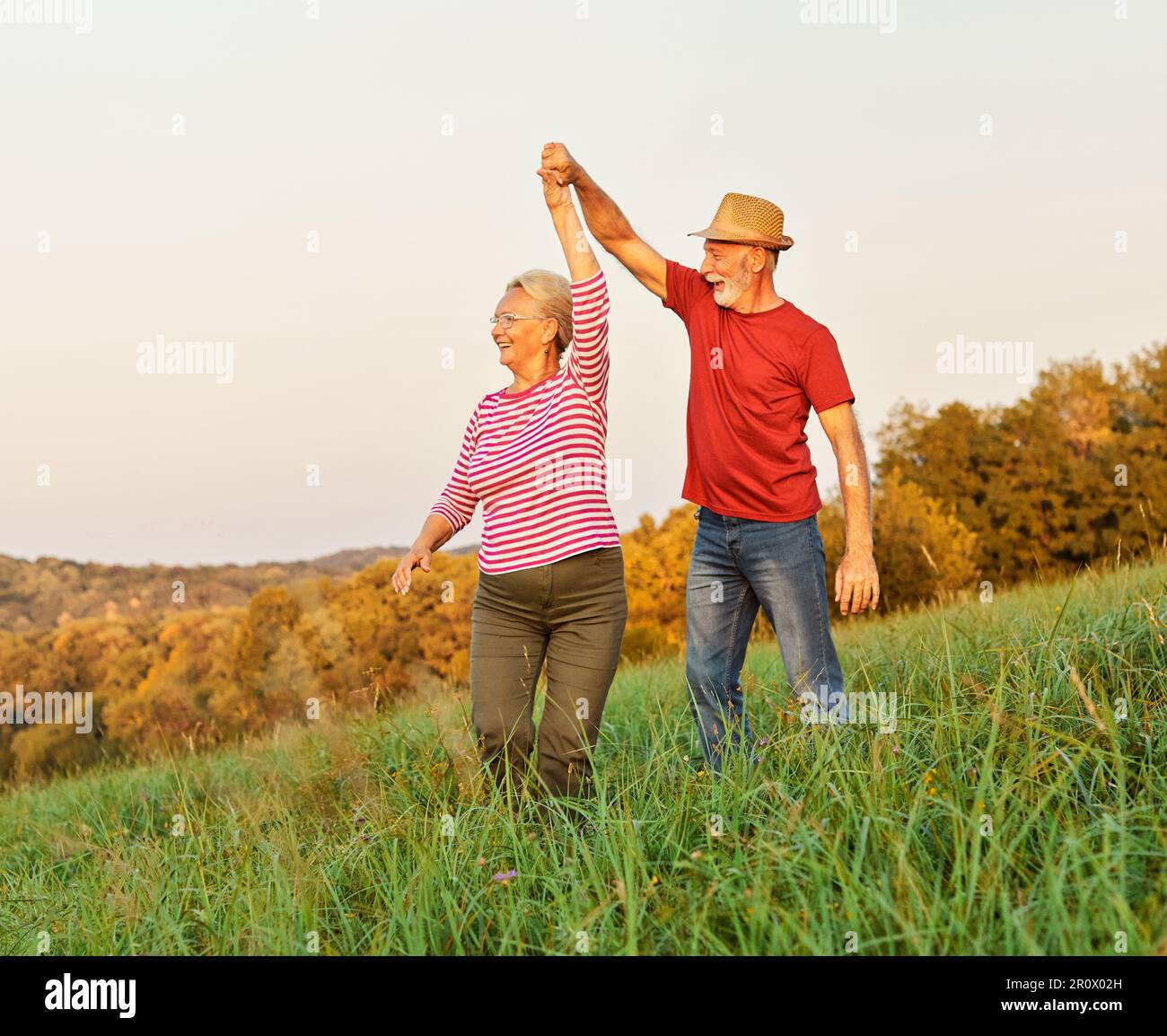 woman man outdoor senior couple happy lifestyle retirement together smiling love dancing nature mature Stock Photo