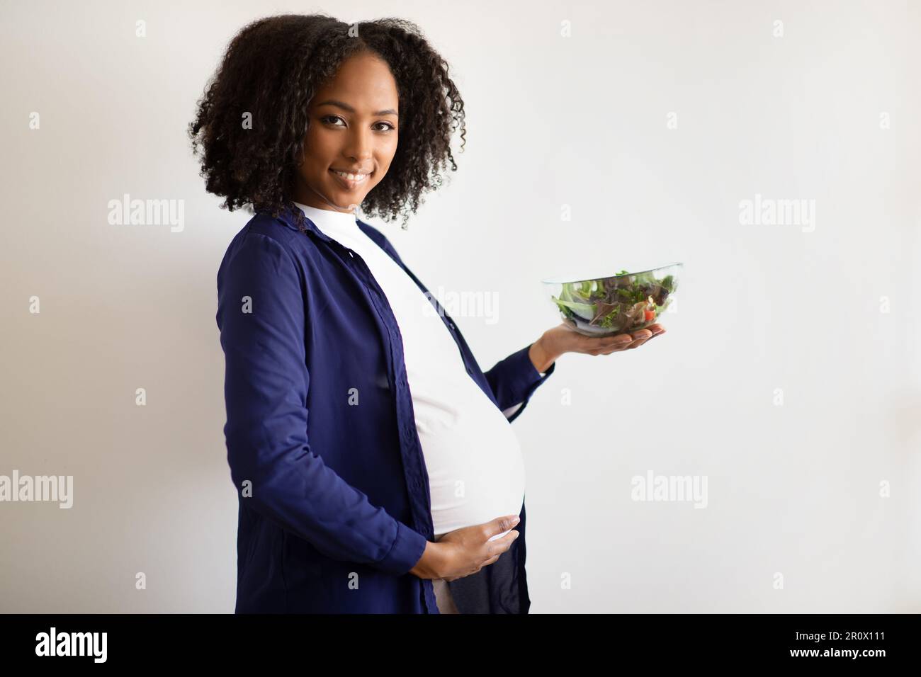 Glad millennial african american pregnant lady with big belly hold ...