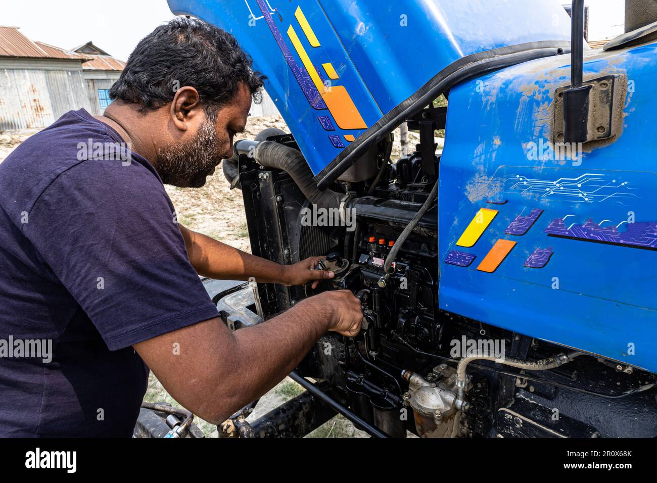 Combine machine service, a mechanic repairing the tractor oil pump and