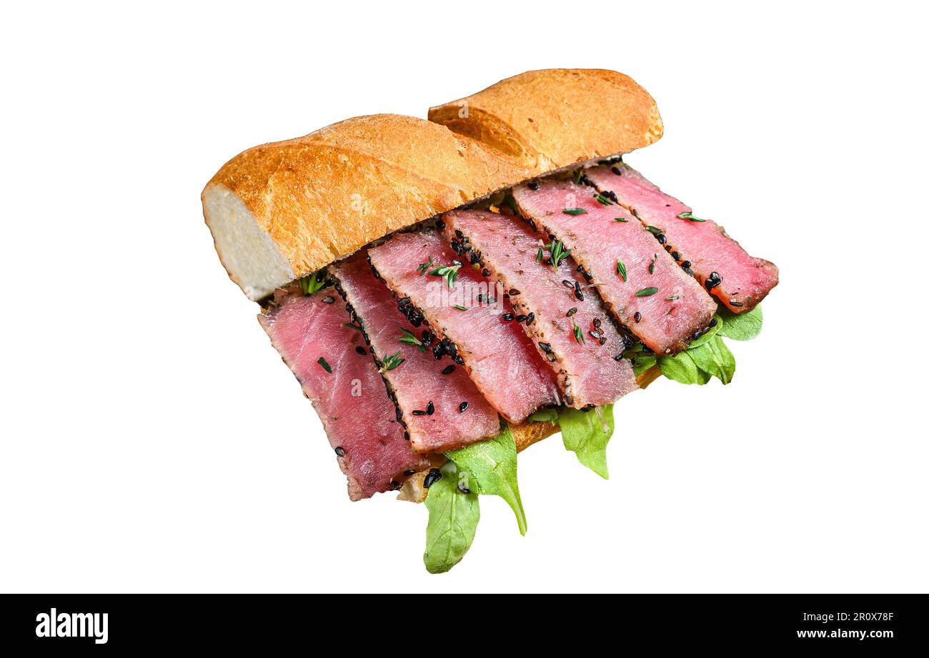 Grilled Ahi Tuna Steak and Avocado Sandwich with arugula on a cutting