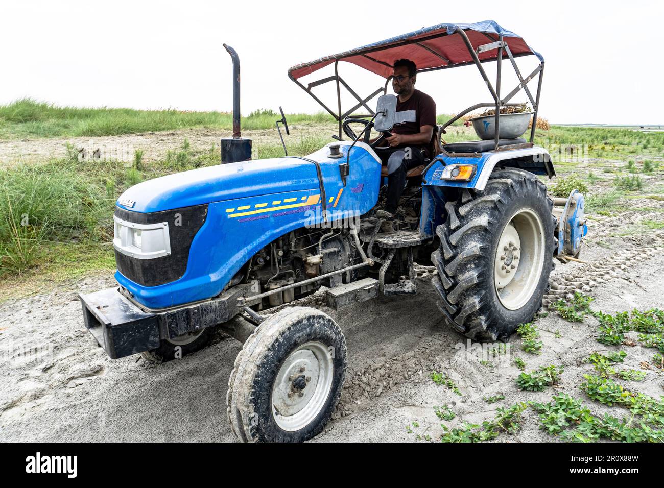 The traktor plows the land, harvesting, preparing for sowing seeds