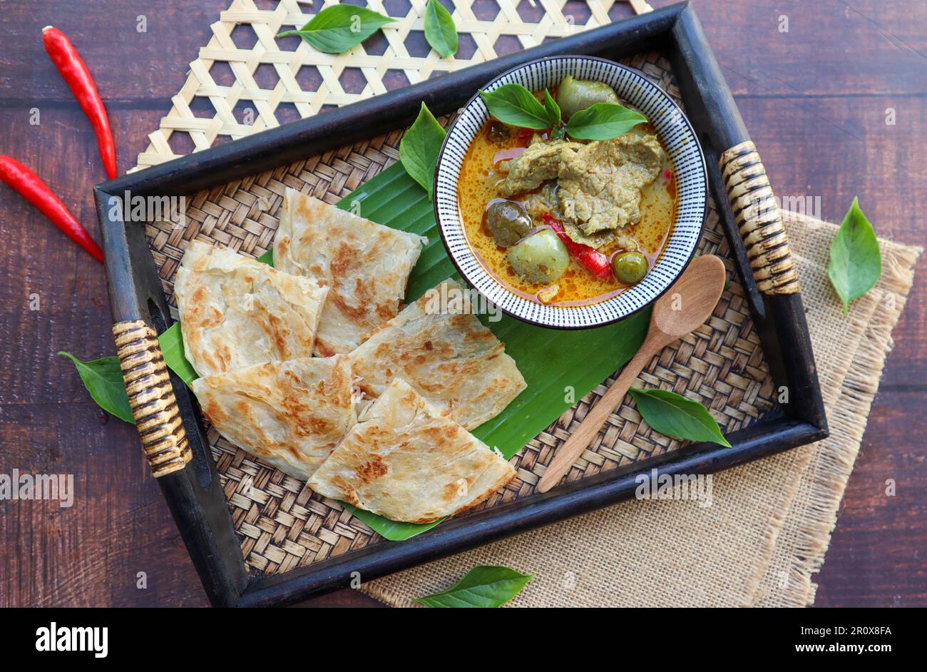 Green curry beef served with Roti at top view - Thai food called Roti Kang Keow Wan , is fusion of Thai authentic food combine with Indian Roti Stock Photo