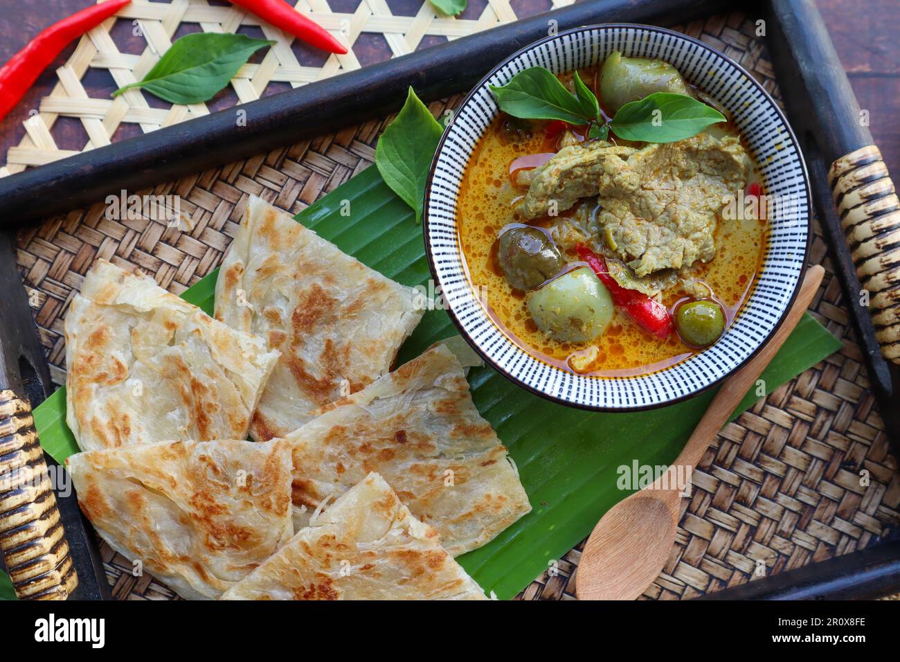 Thai green curry beef served with Roti at top view - Thai food called Roti Kang Keow Wan , is fusion of Thai authentic food combine with Indian Roti Stock Photo