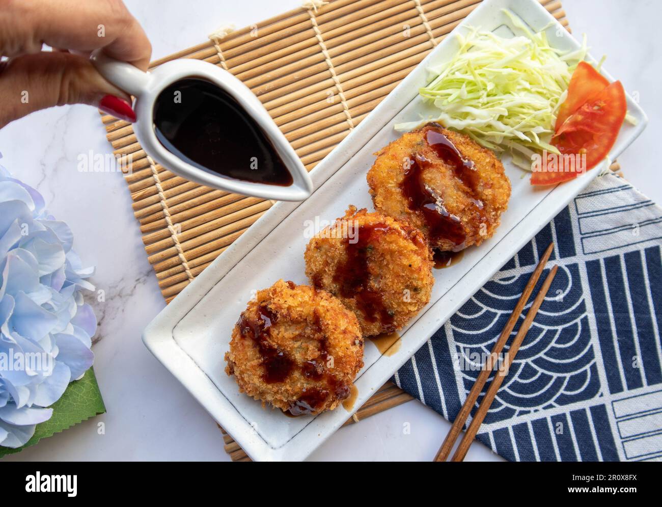 Korokke Japanese appetizer of deep fried mashed potatoes, crab sticks