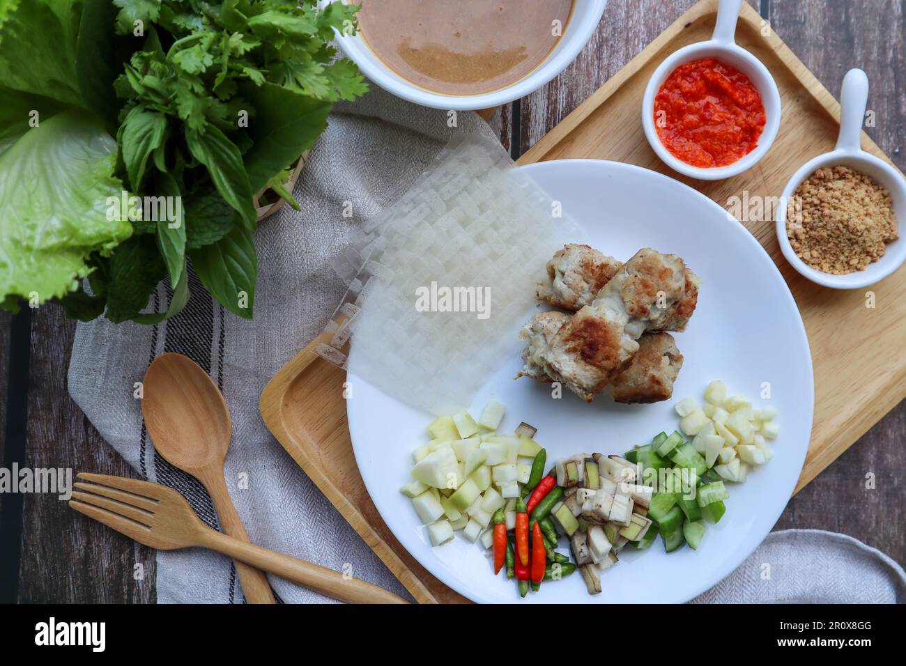 Nem Nuong - Vietnamese food of grilled pork sausage eat with rice paper and vegetables Stock Photo