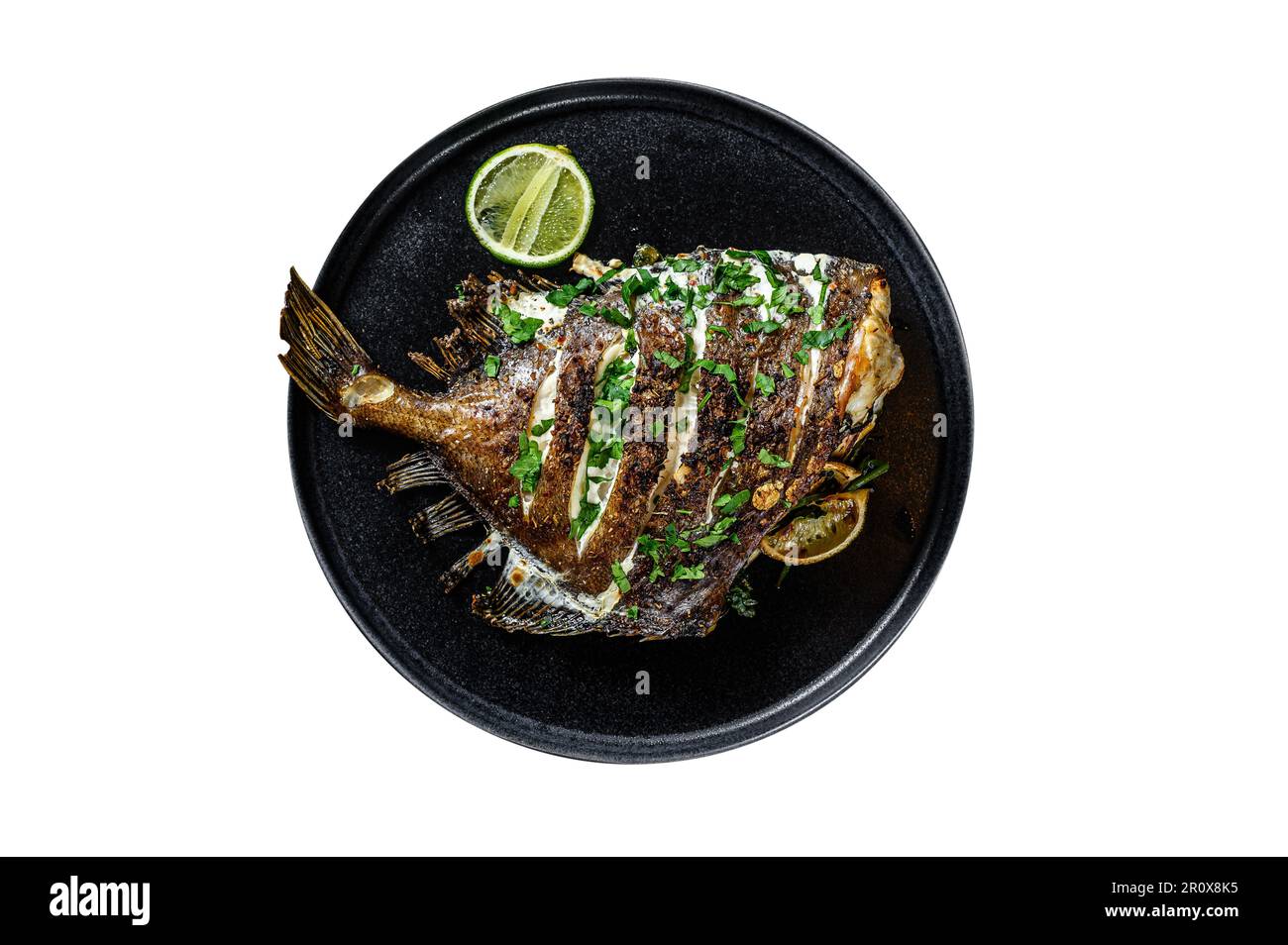 Fried Dory fish with lime and parsley in a pan. Vegatarian health food