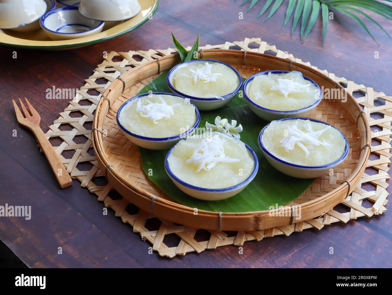 Steamed Cassava cake top with coconut at close up view - Thai dessert called Kamon Mun Stock Photo