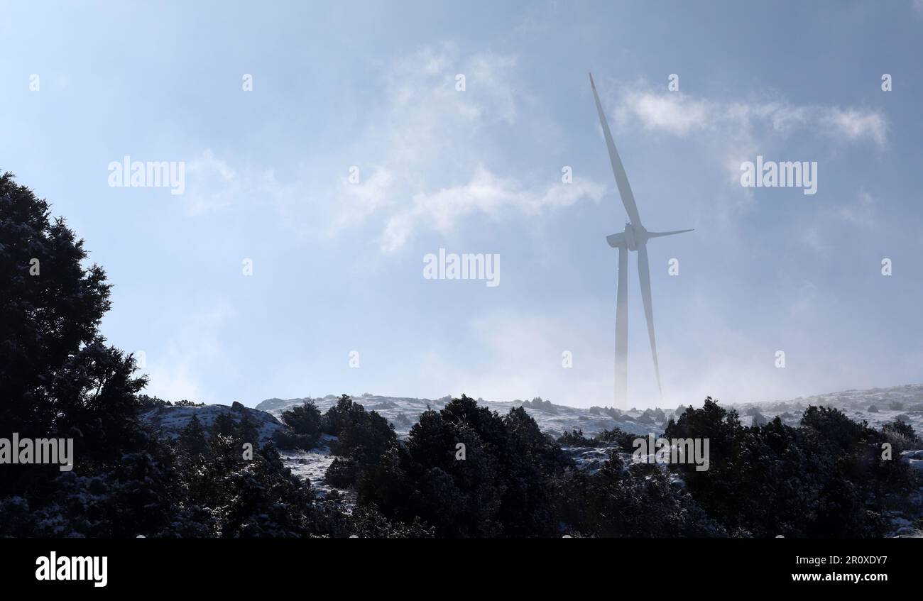 Wind turbine against blue sky. Stock Photo
