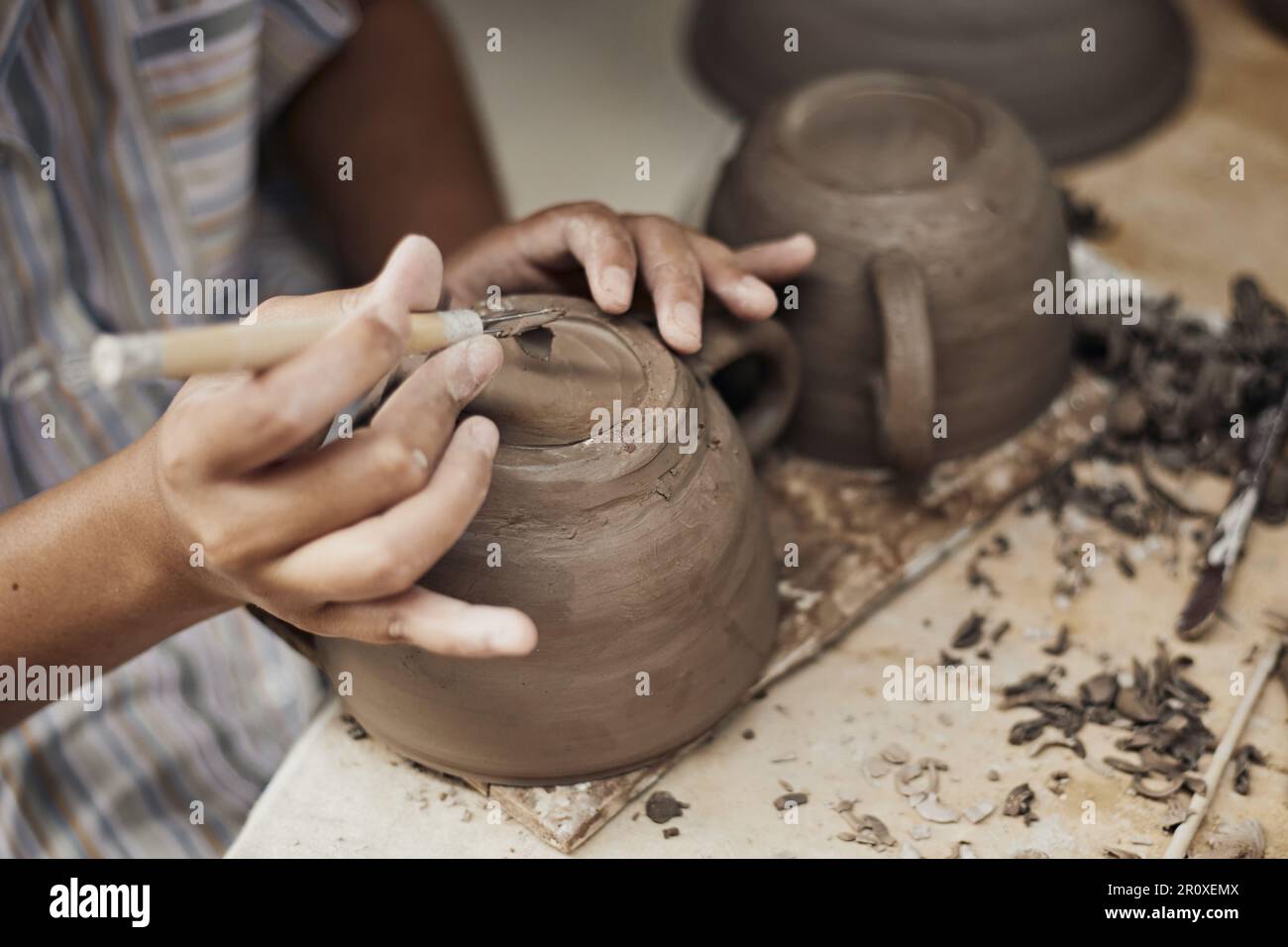 Pottery workshop, the process of making ceramic tableware, women’s hands Stock Photo