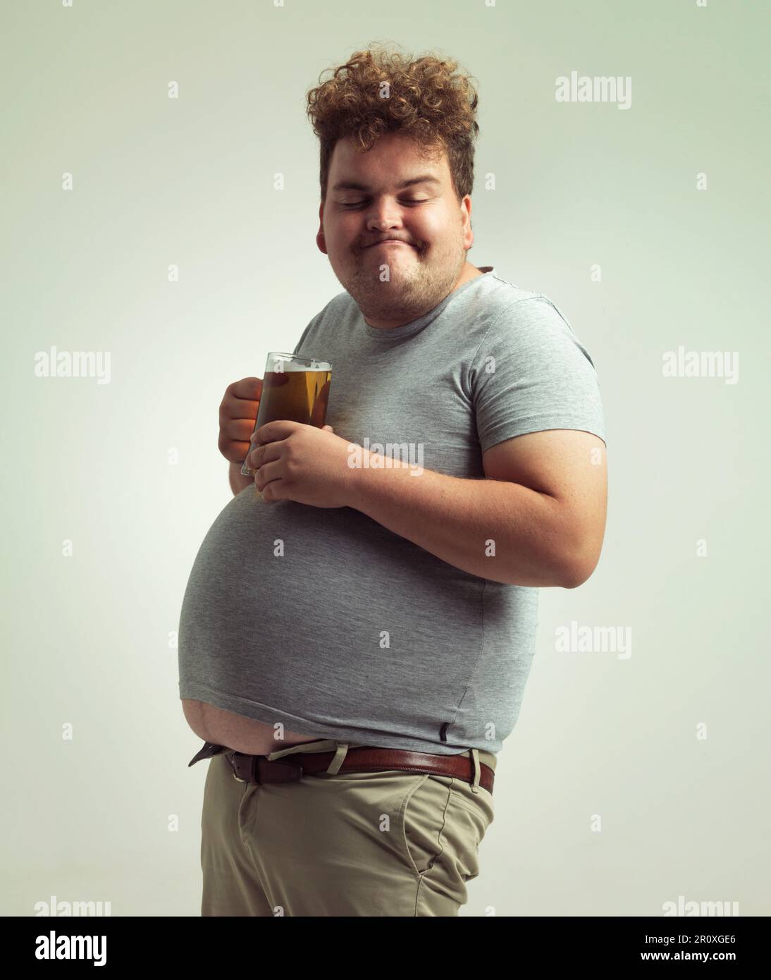 Nothing better than beer after a long day. an overweight man looking