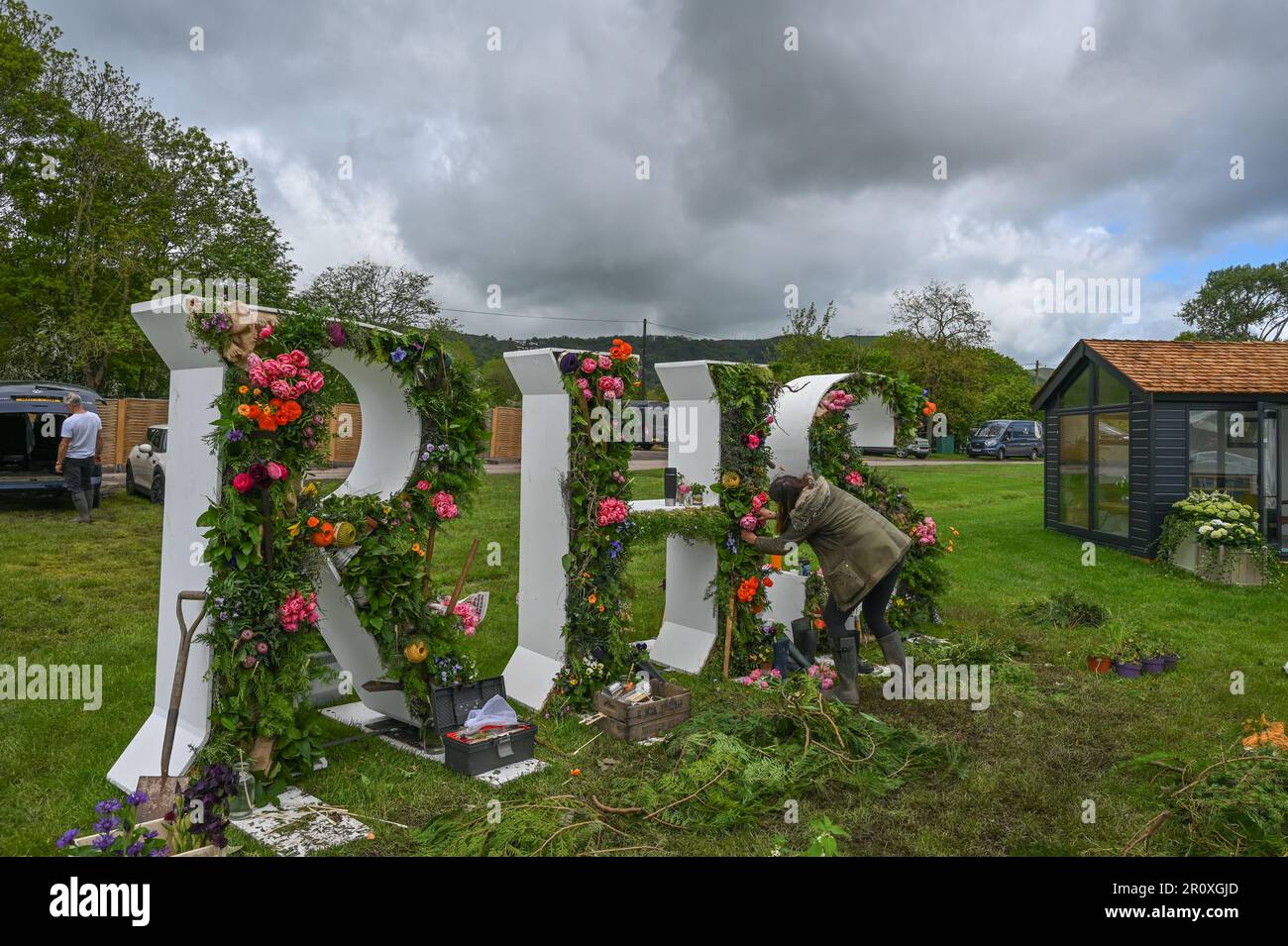 Malvern, Worcestershire, UK. 10th May 2023. RHS Malvern Spring  Finishing touches being made to the floral RHS logo for this years RHS Malvern Spring festival. Credit SImon Maycock / Alamy Live News. Stock Photo