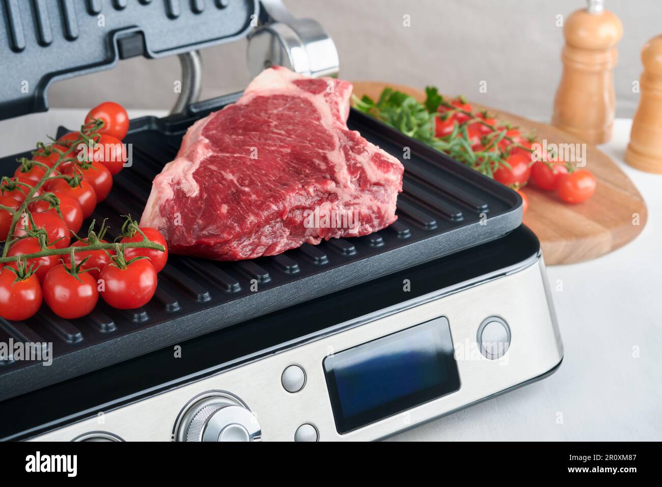 Raw prime steaks on electric grill. Black angus prime meat steaks