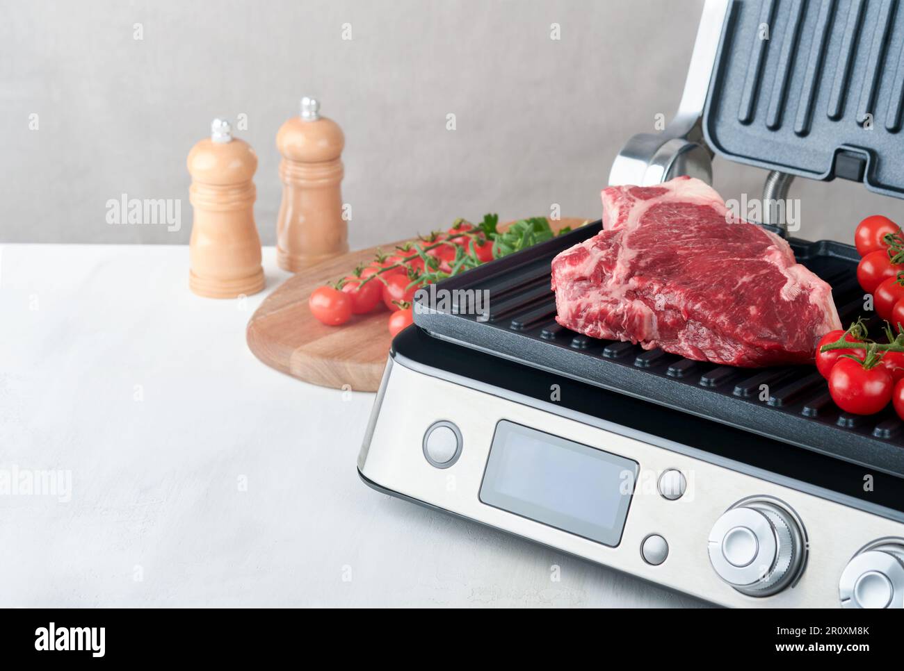 Raw prime steaks on electric grill. Black angus prime meat steaks