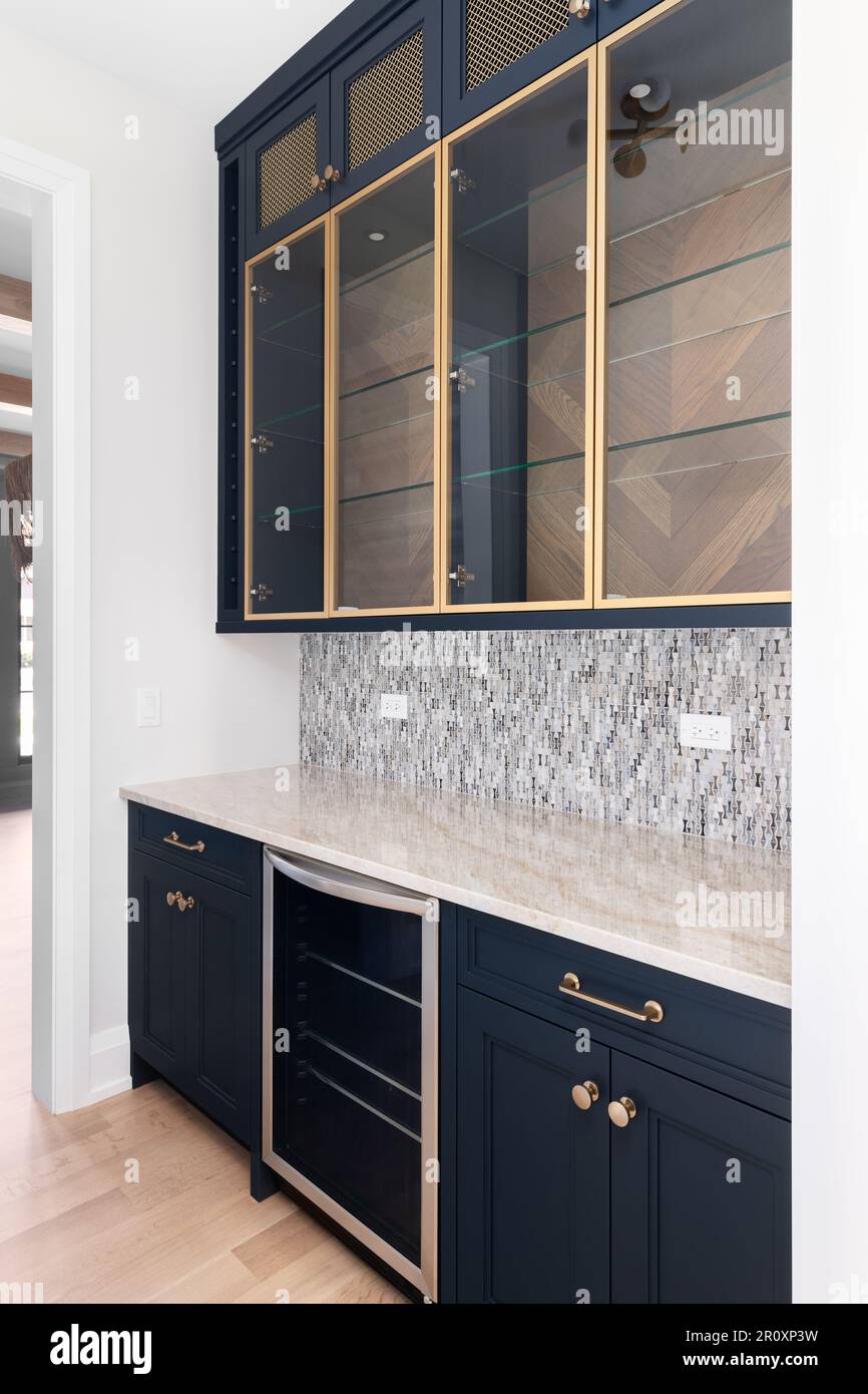 A butler's pantry with blue with gold accents, pattern tile