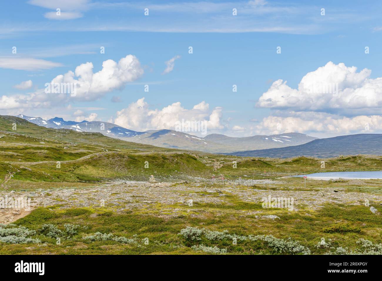 Mountainous landscape view with a footpath and a lake Stock Photo