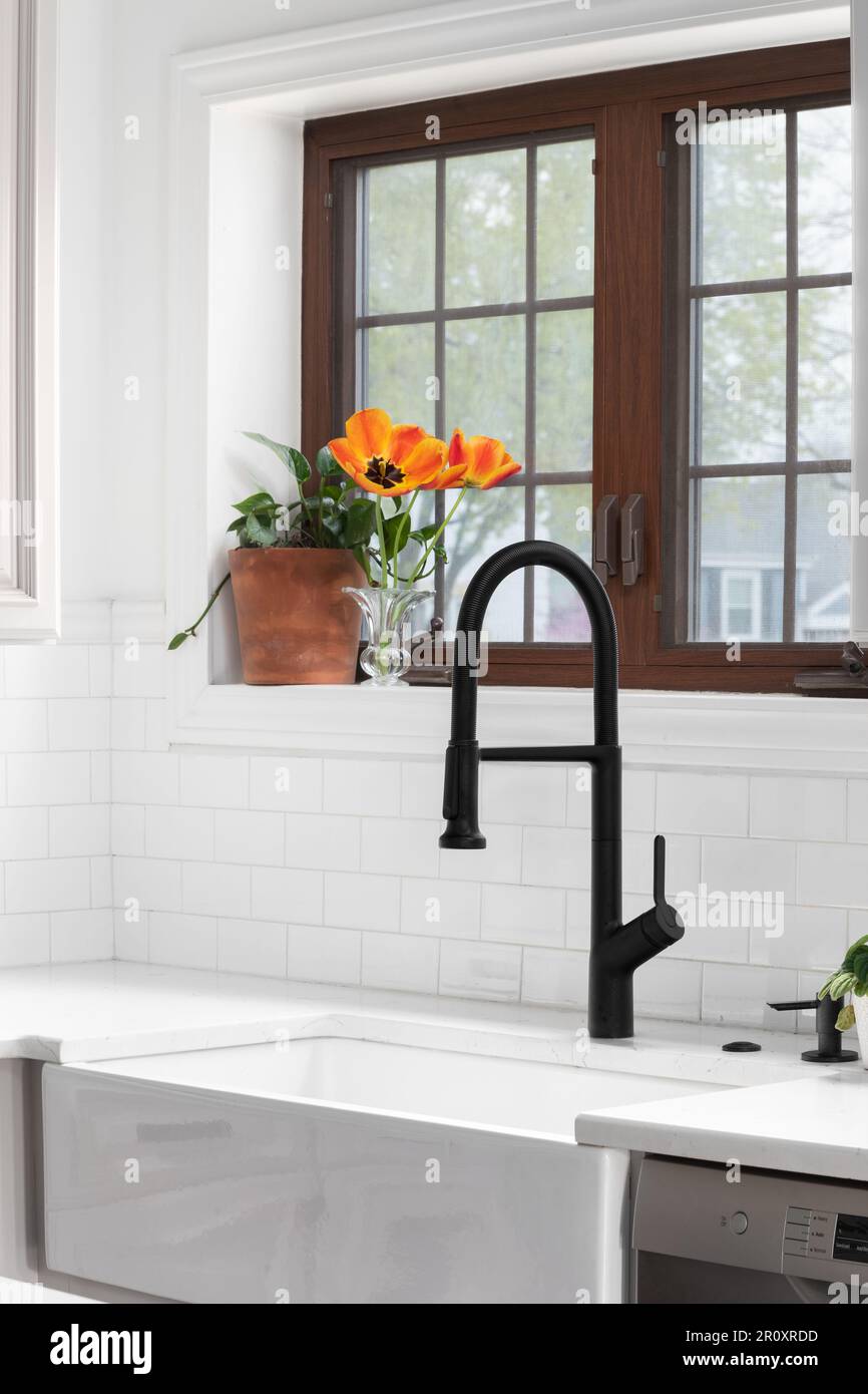 A beautiful walkin shower with marble tiled walls, black circular tile