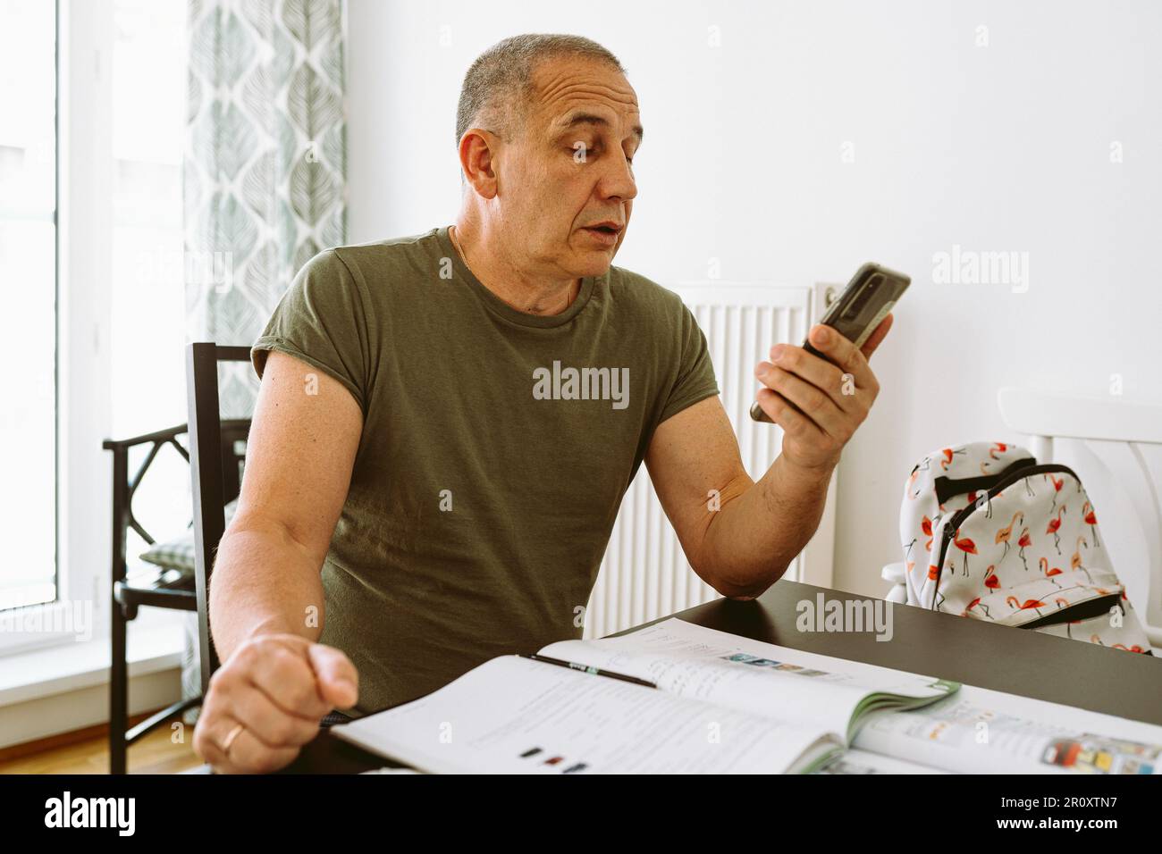 middle-aged man writes notes in notebook Stock Photo