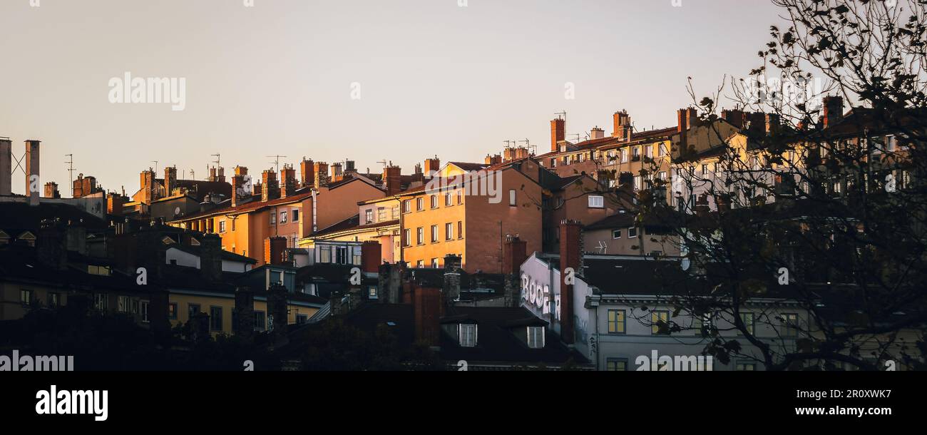 The buildings illuminated by golden light at sunset in La Croix-Rousse. Lyon, France. Stock Photo