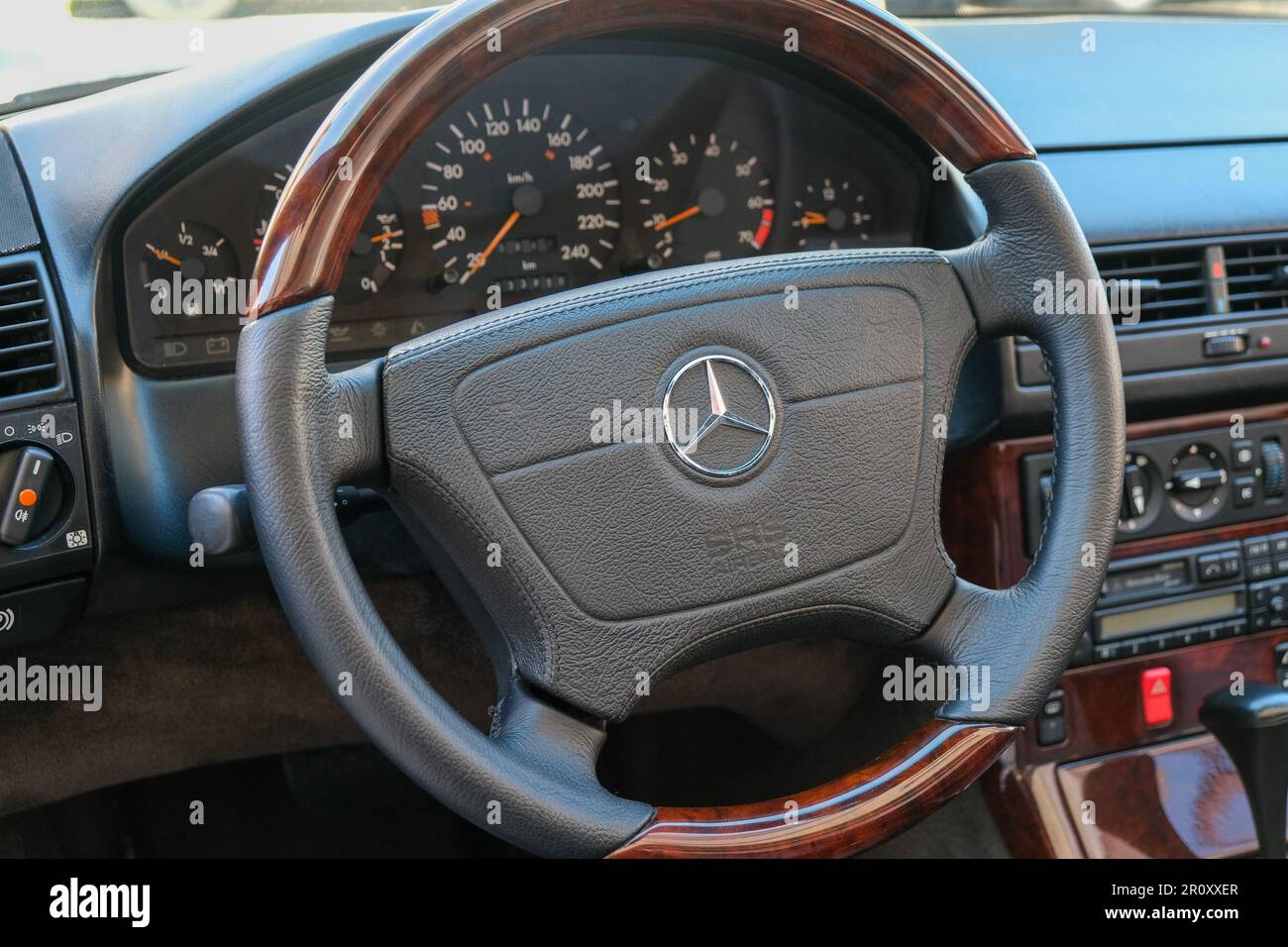 Close up Mercedes logo wheel with interior of old Mercedes display screen. Stock Photo