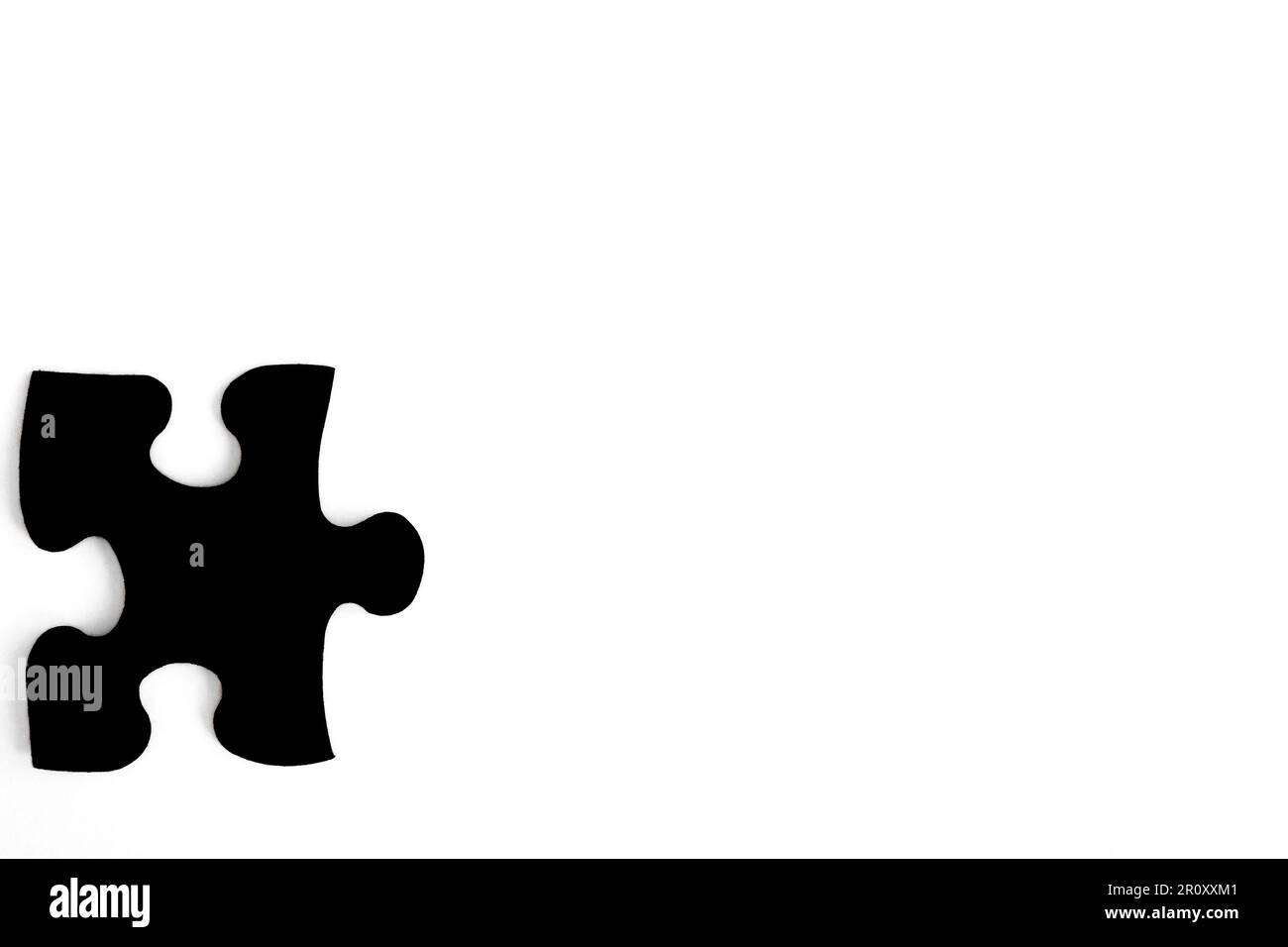 black puzzle piece on white background Stock Photo - Alamy