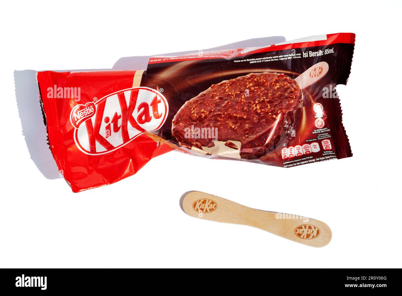 Ho Chi Minh City, Vietnam - May 10, 2023: KitKat ice cream torn wrapper isolated on white. Popular dessert Kit Kat red packaging and a stick with bran Stock Photo