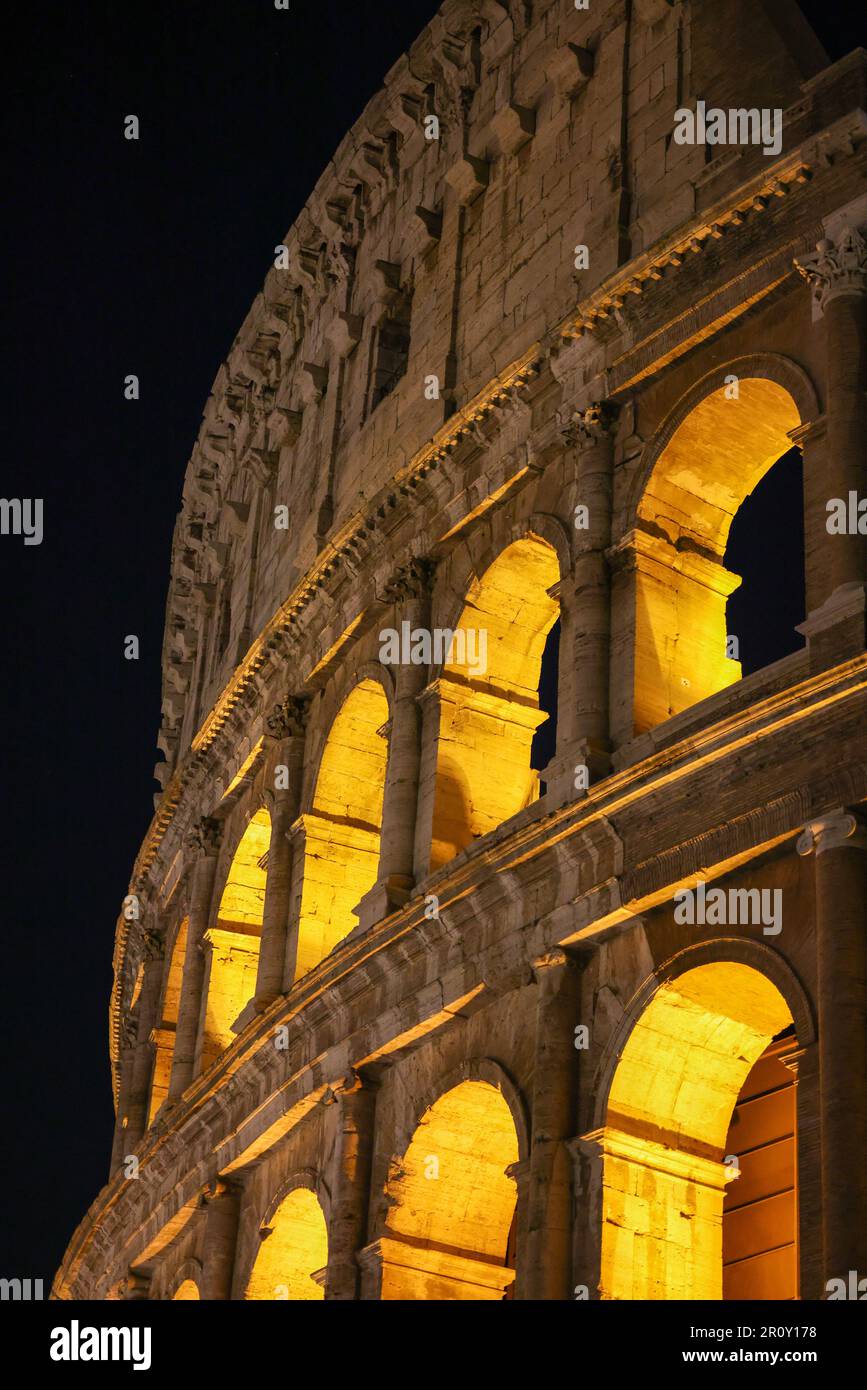 The iconic Coliseum of Rome, Italy illuminated by the lights at night ...