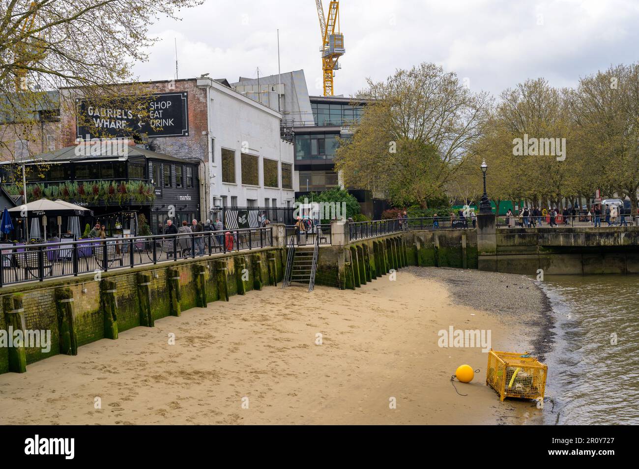 LONDON - April 21, 2023: Enjoy the urban buzz of Southbank's bars and restaurants, or unwind on the sandy riverside beach. Stock Photo