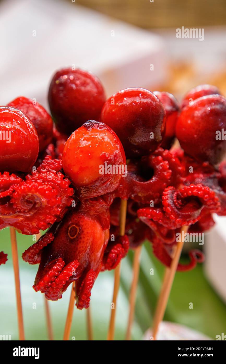 Baby marinated octopus on a stick. Japanese delicacy at an Osaka fish